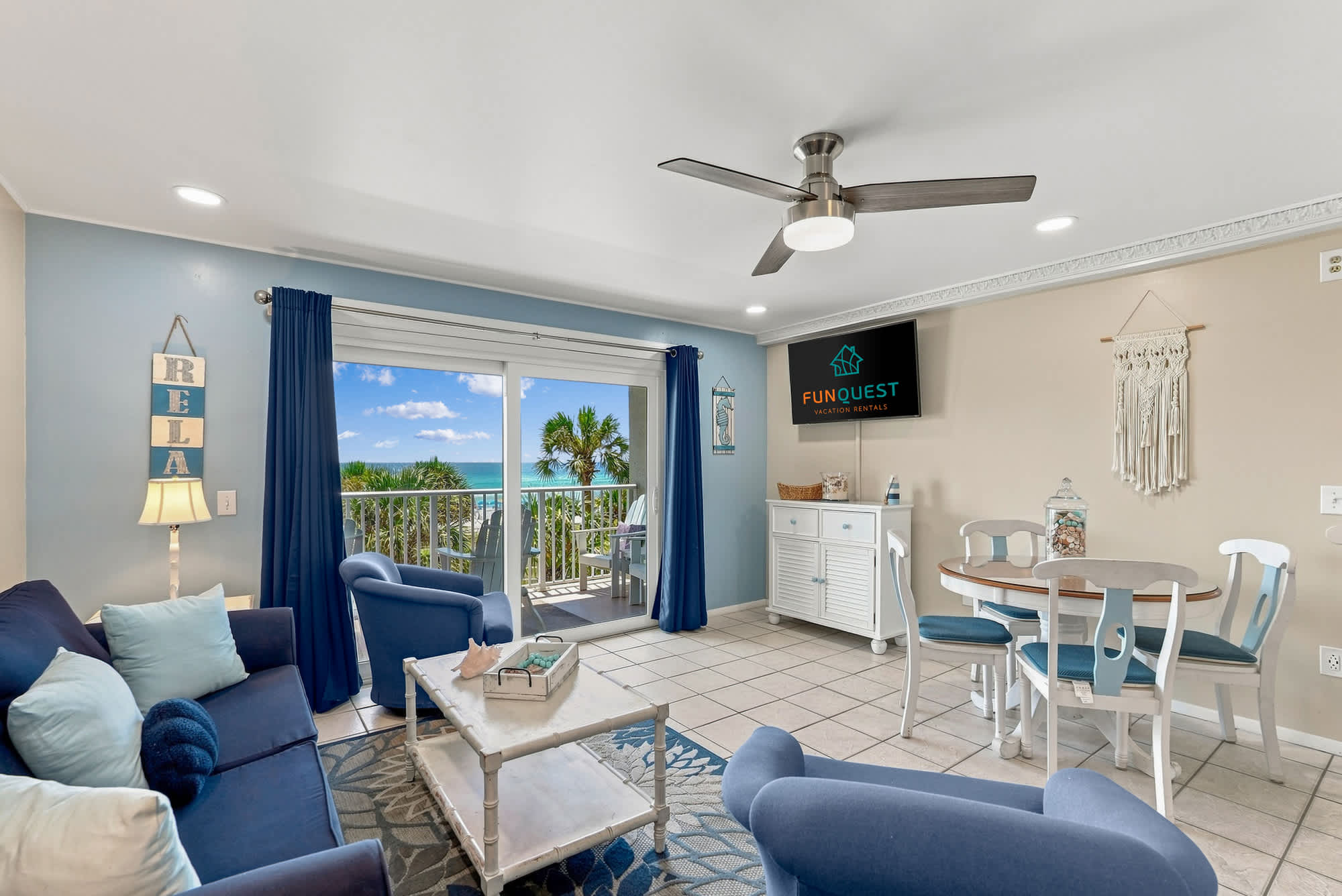 The Summit 308  – Cozy living area with a view of the ocean, white furniture, and blue accent decor.