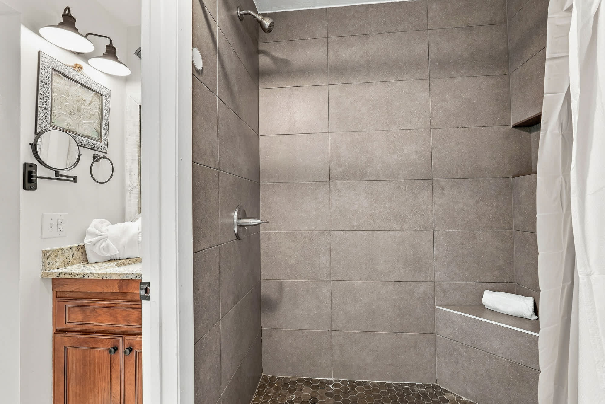 The Summit 225 – Contemporary bathroom featuring a spacious shower, granite counter, and towel rack.