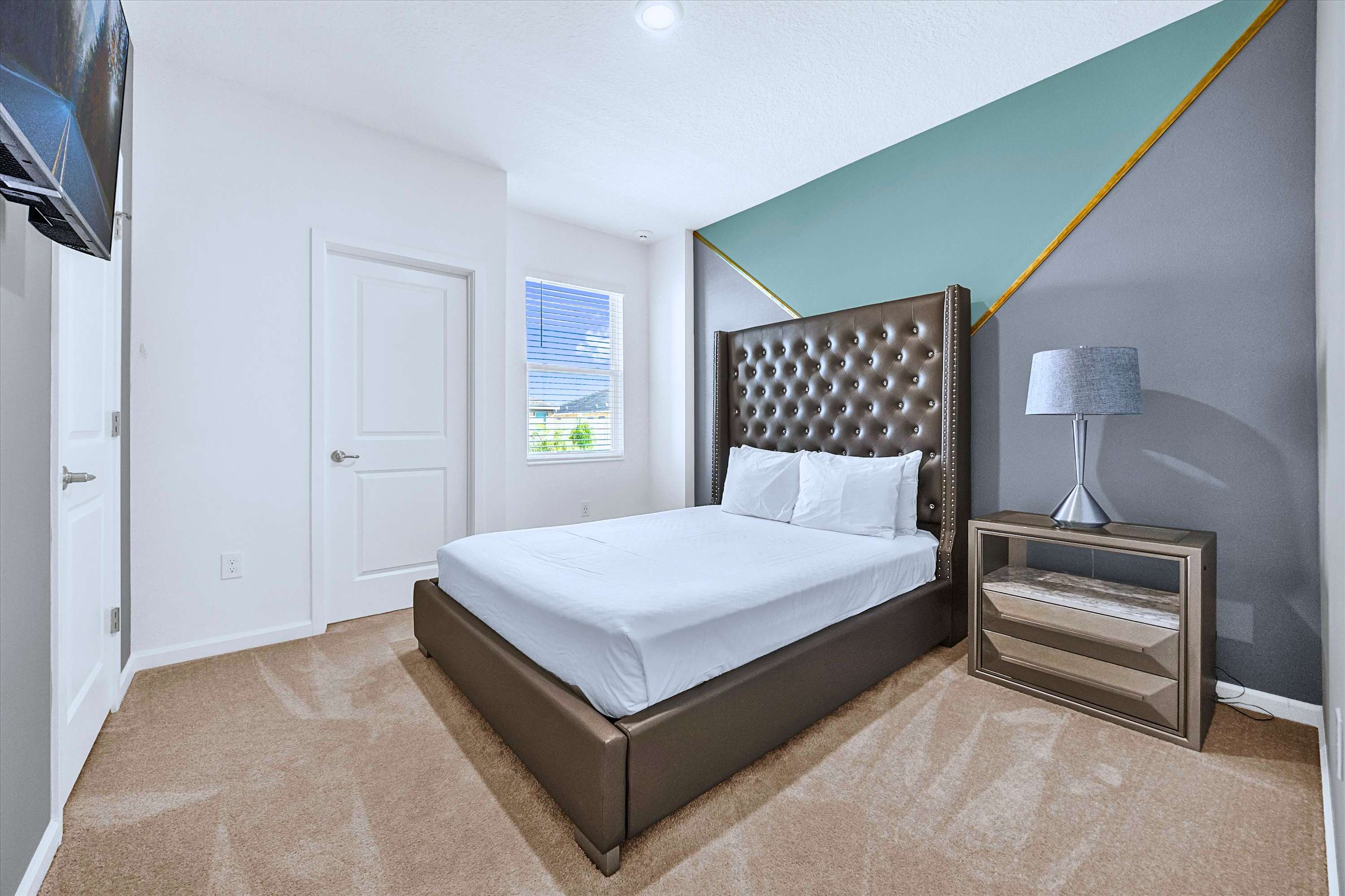Unwind in comfort: Queen Bed equipped with custom headboard, luxury linens & side lamp