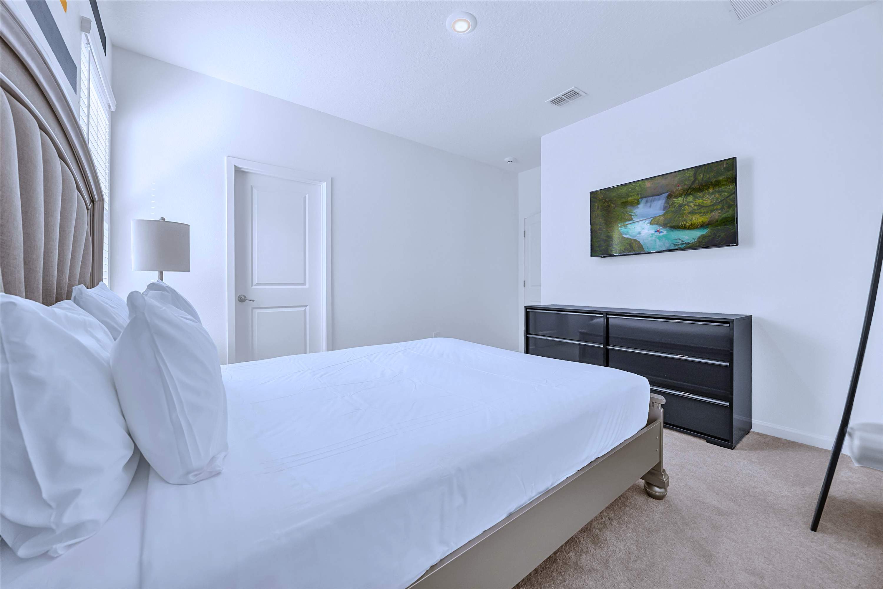 Stream from bed: Queen Bed layout with flat-screen TV and media cabinet storage