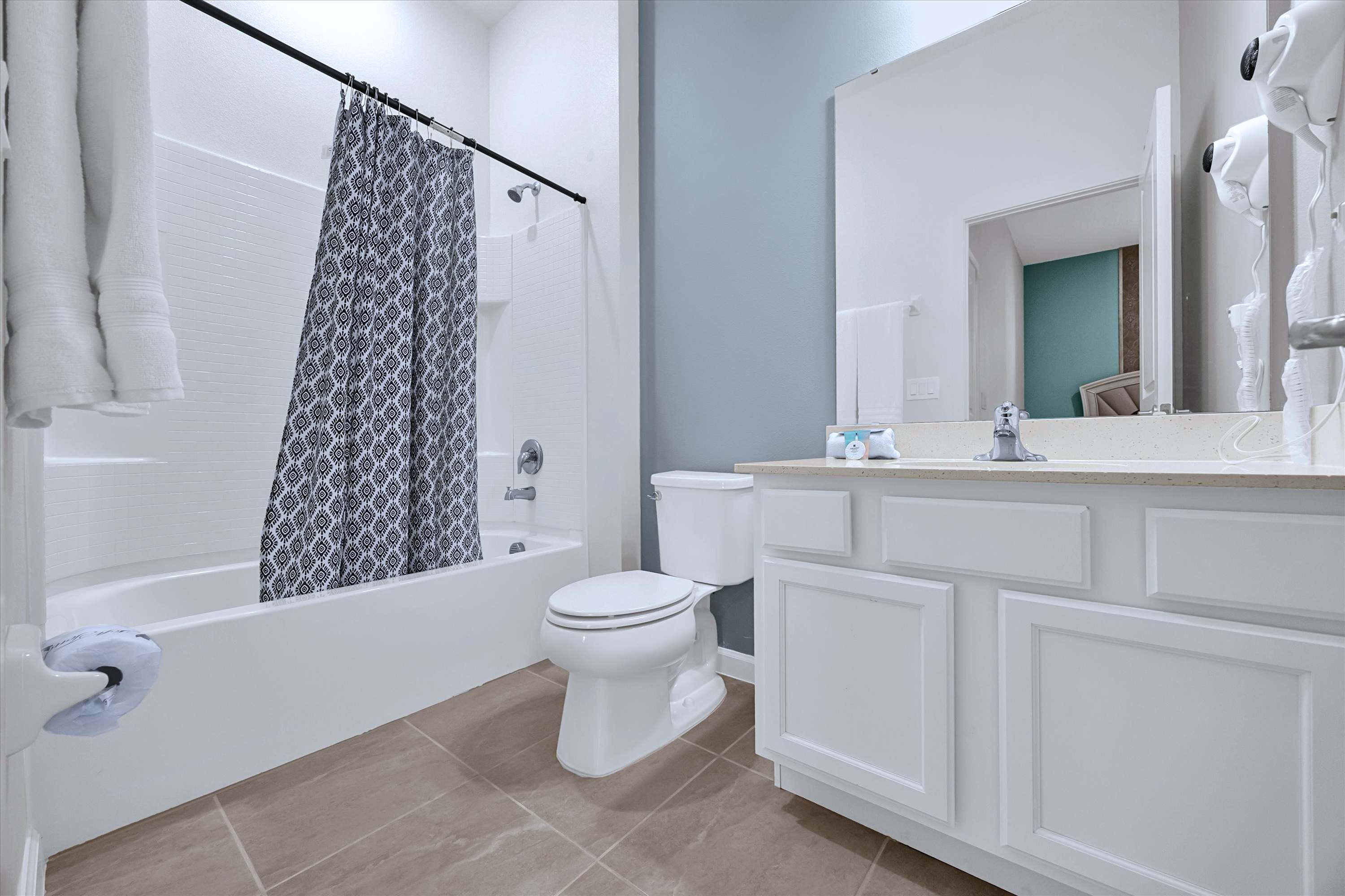 Private en-suite bath equipped with bathtub, shower, toilet, sink vanity & mirror