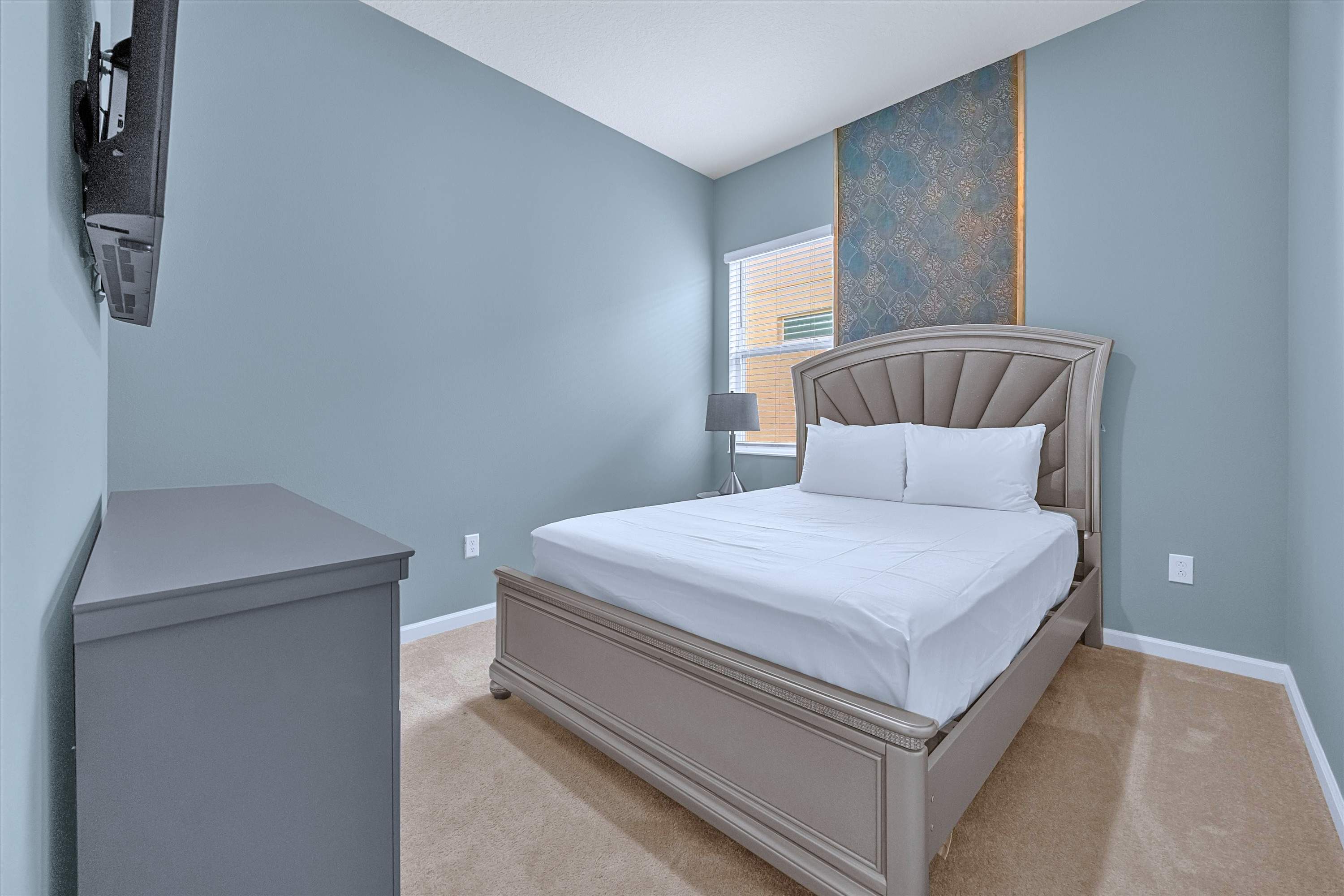 Queen Bed with decorative accent wall, custom headboard, smart TV & media cabinet