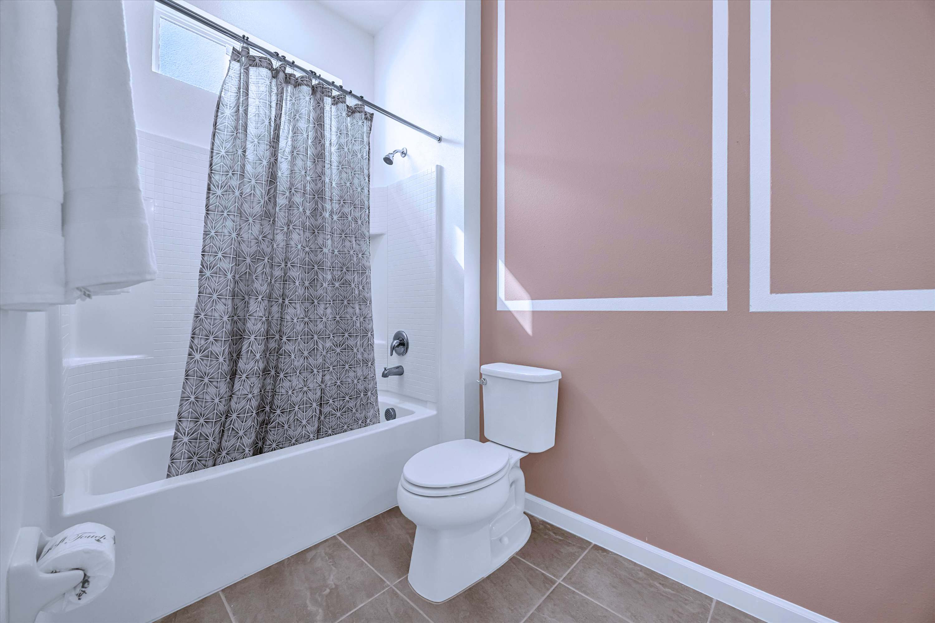 En-suite full bathroom view showcasing a single-sink vanity and large mirror