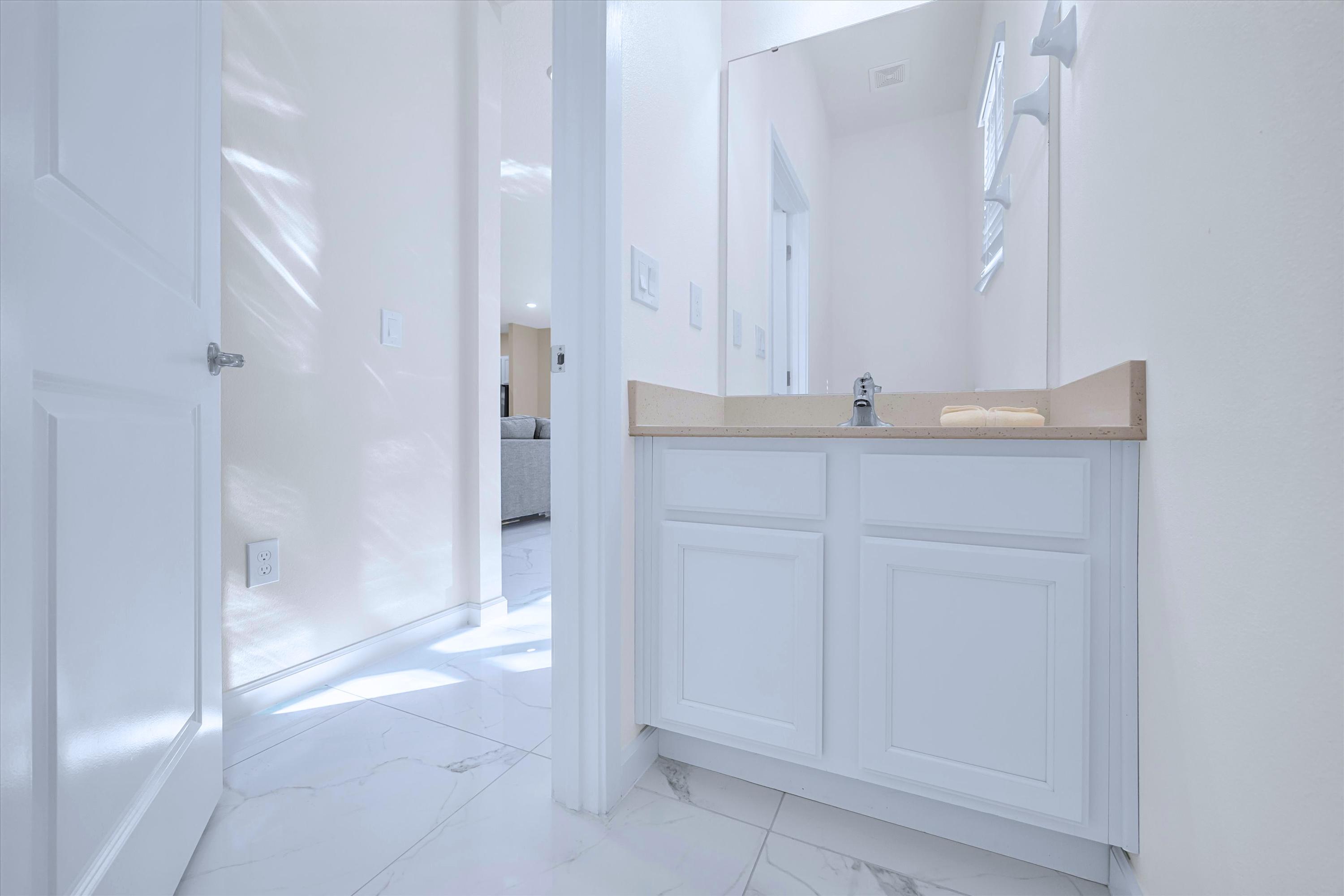 Convenient ground-floor powder room featuring a modern sink vanity and toilet