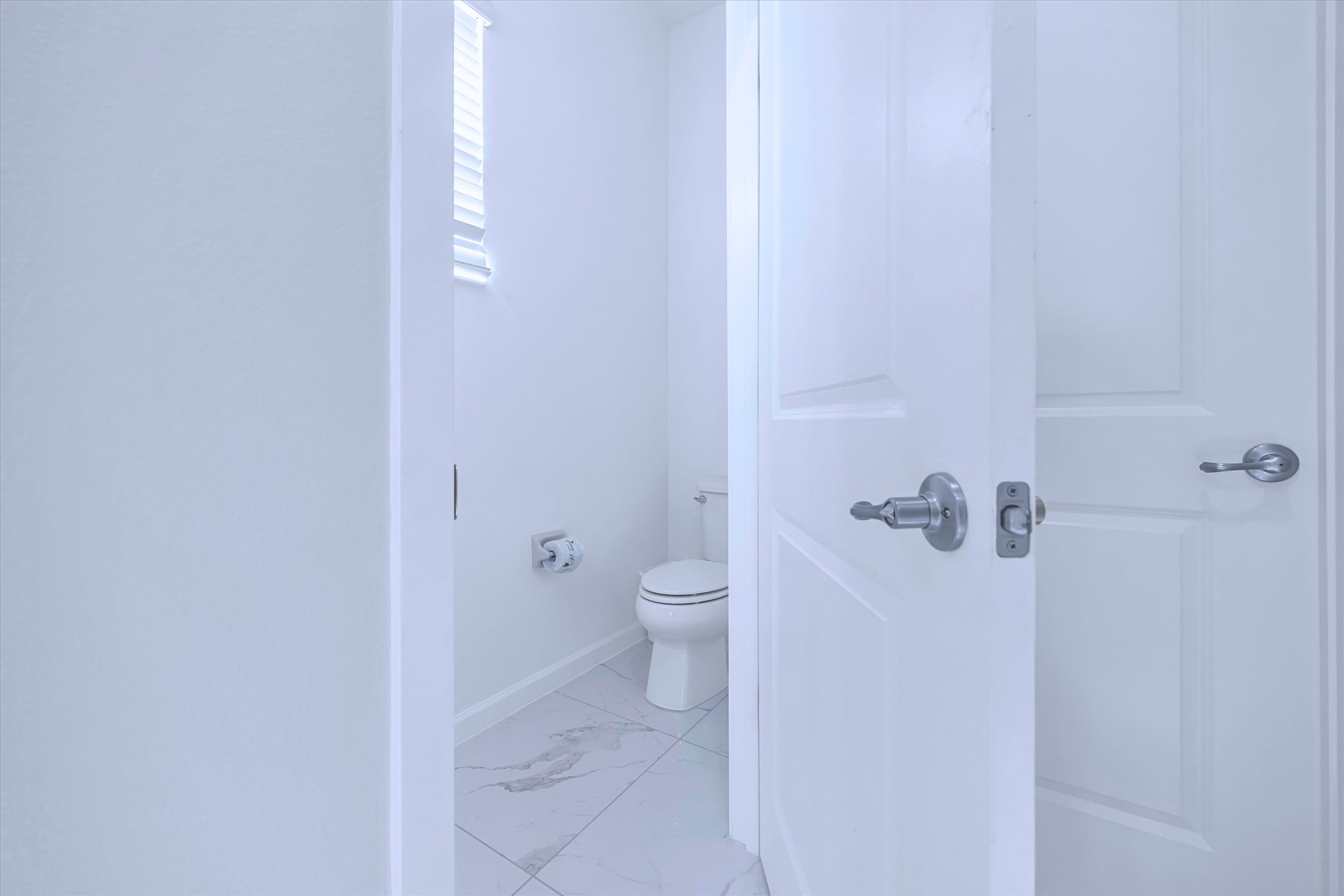 Convenient half bathroom featuring a clean toilet and guest-friendly layout