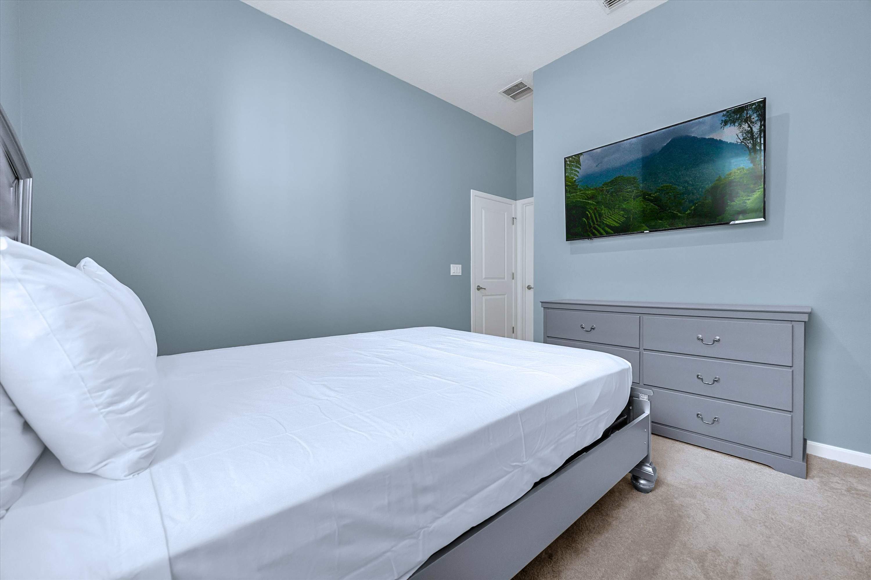 Relax in your queen bed with a flat-screen TV & convenient storage cabinet below