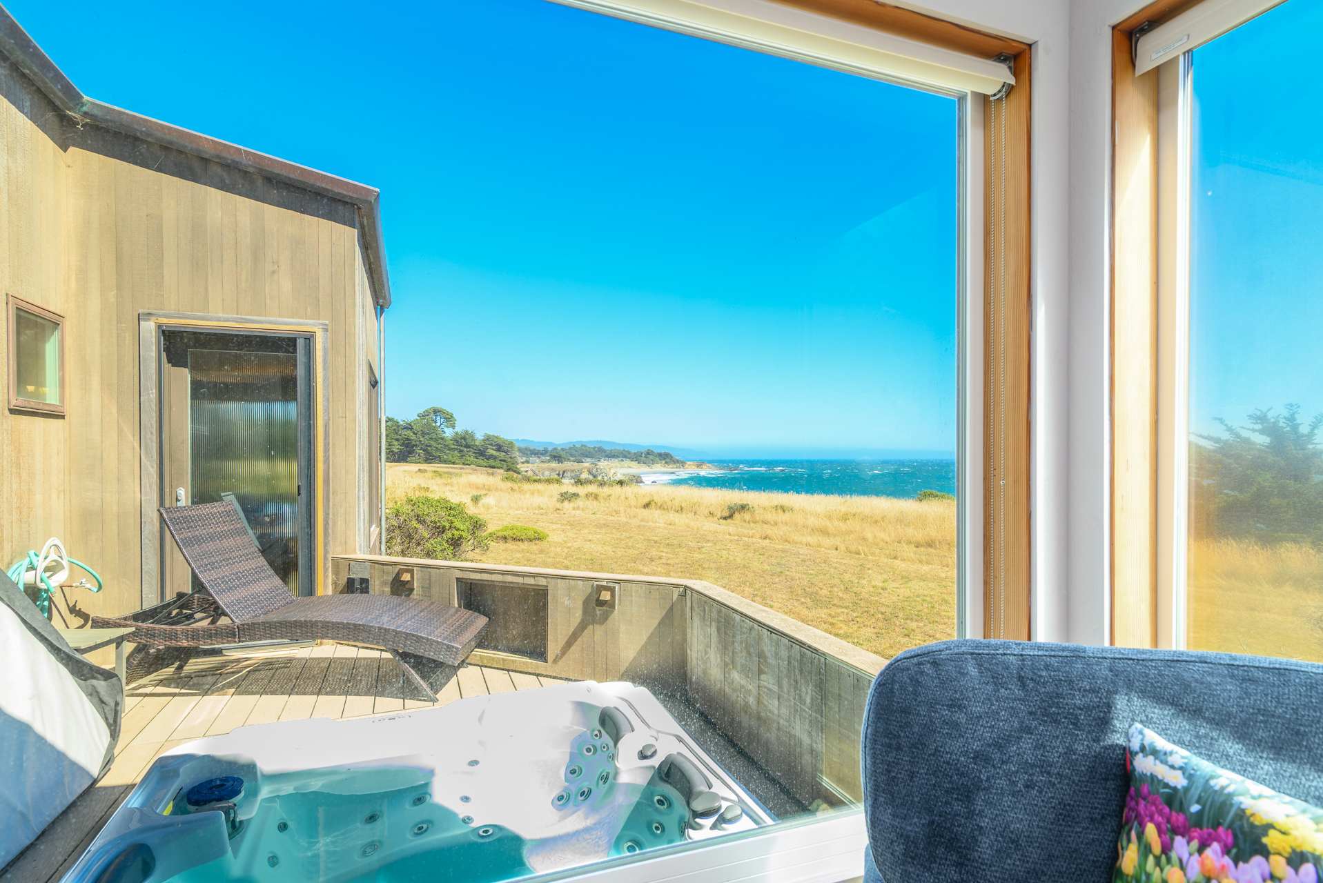 Private outdoor hot tub on deck with ocean views