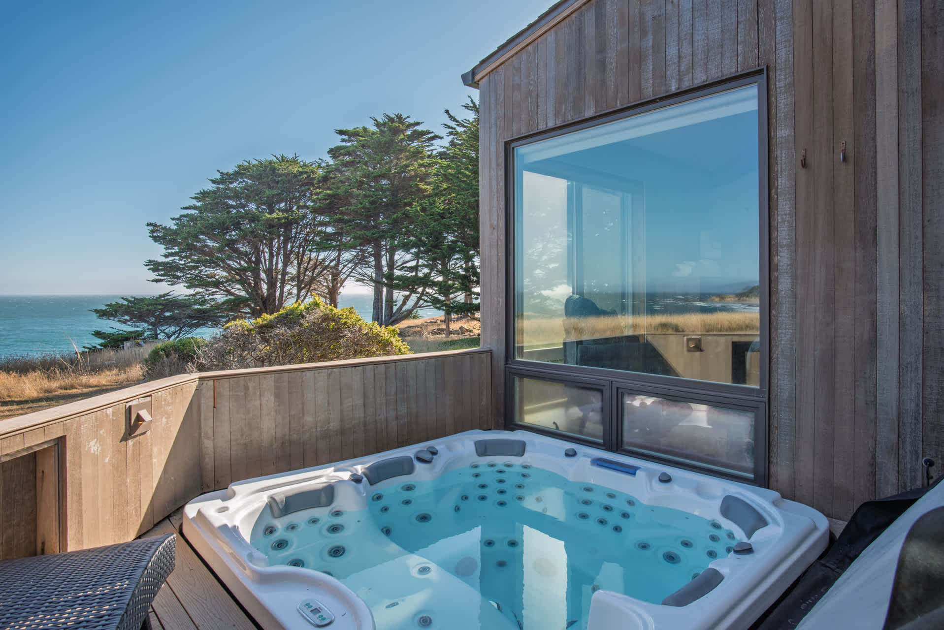 Private outdoor hot tub on deck with ocean views