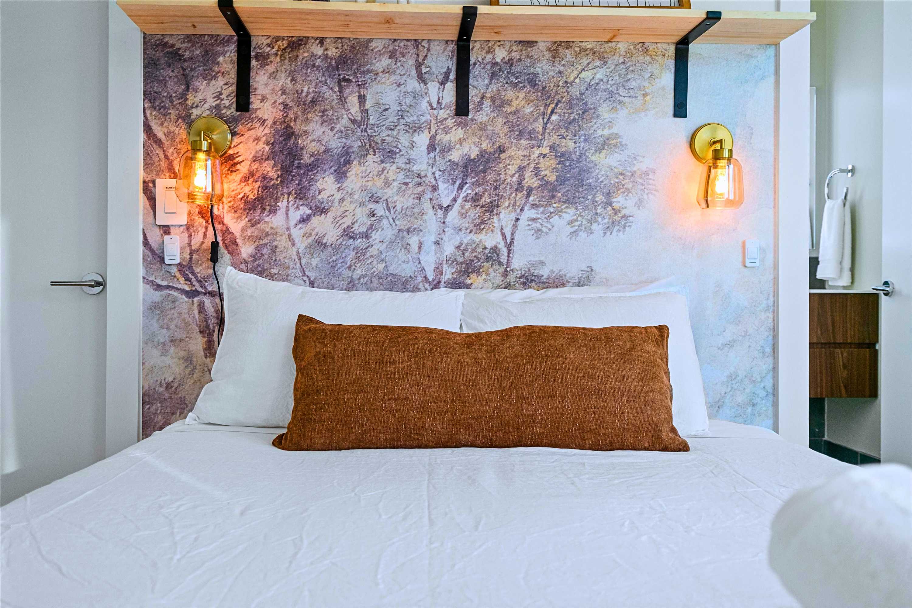 Designer Queen Bed Featuring Stylish Wall Accent Lamps