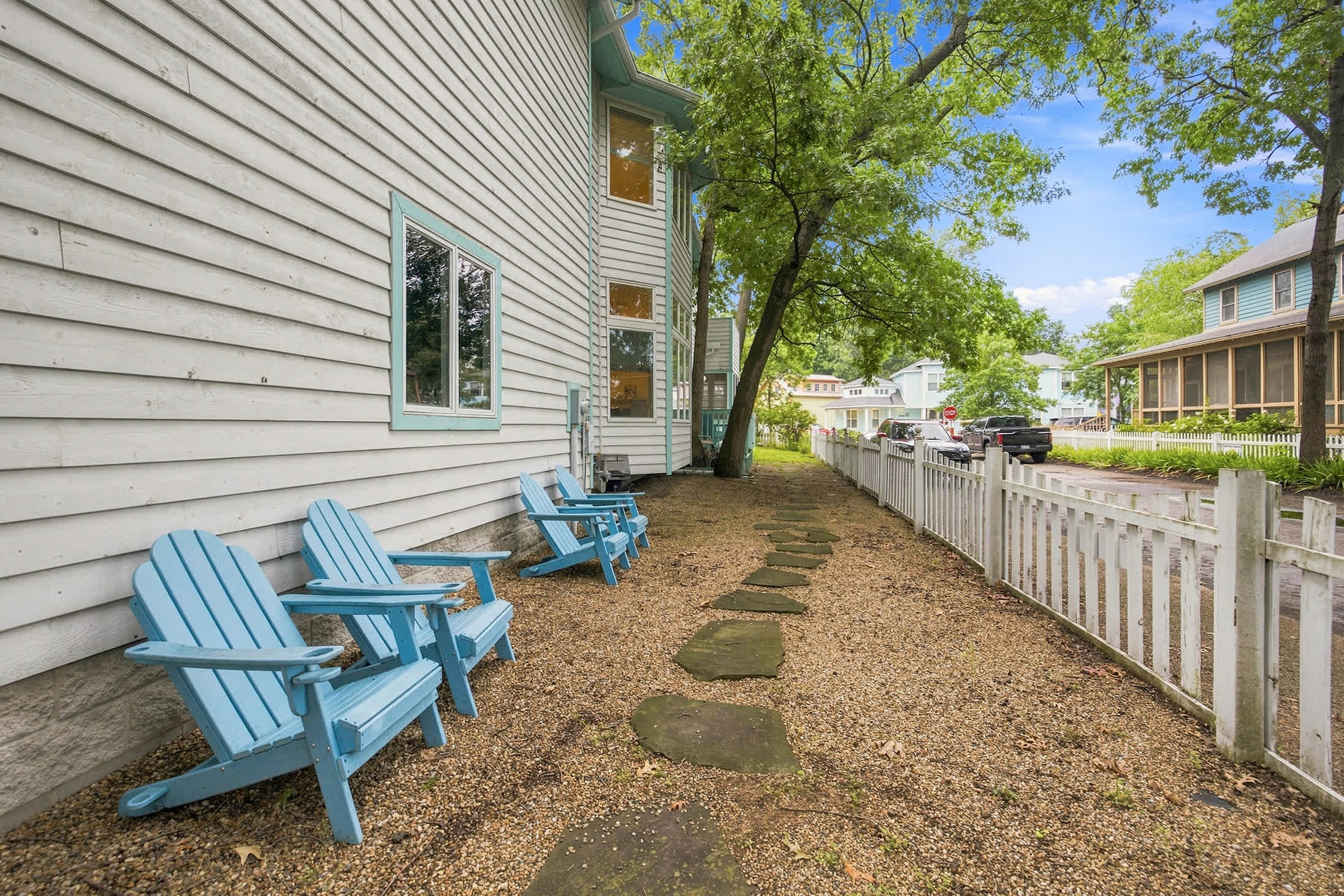 Side yard with Adirondack seating offers an extra spot to relax outdoors.