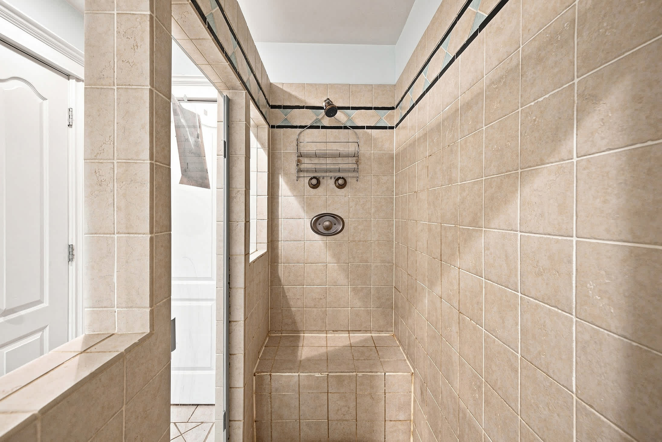 Spacious tiled walk-in shower offers added comfort and easy access.