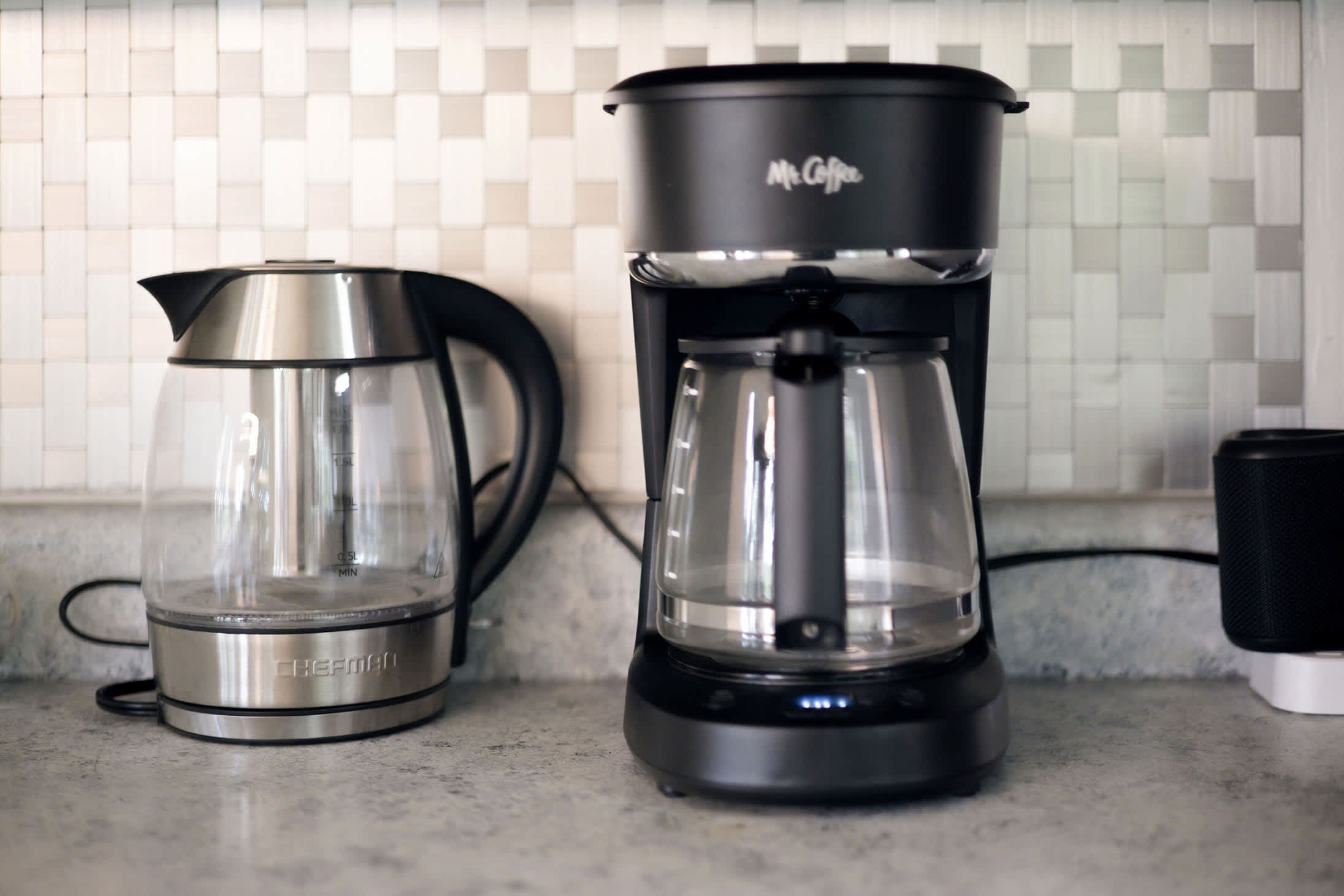 Kitchen coffee station includes a drip coffee maker and electric kettle.