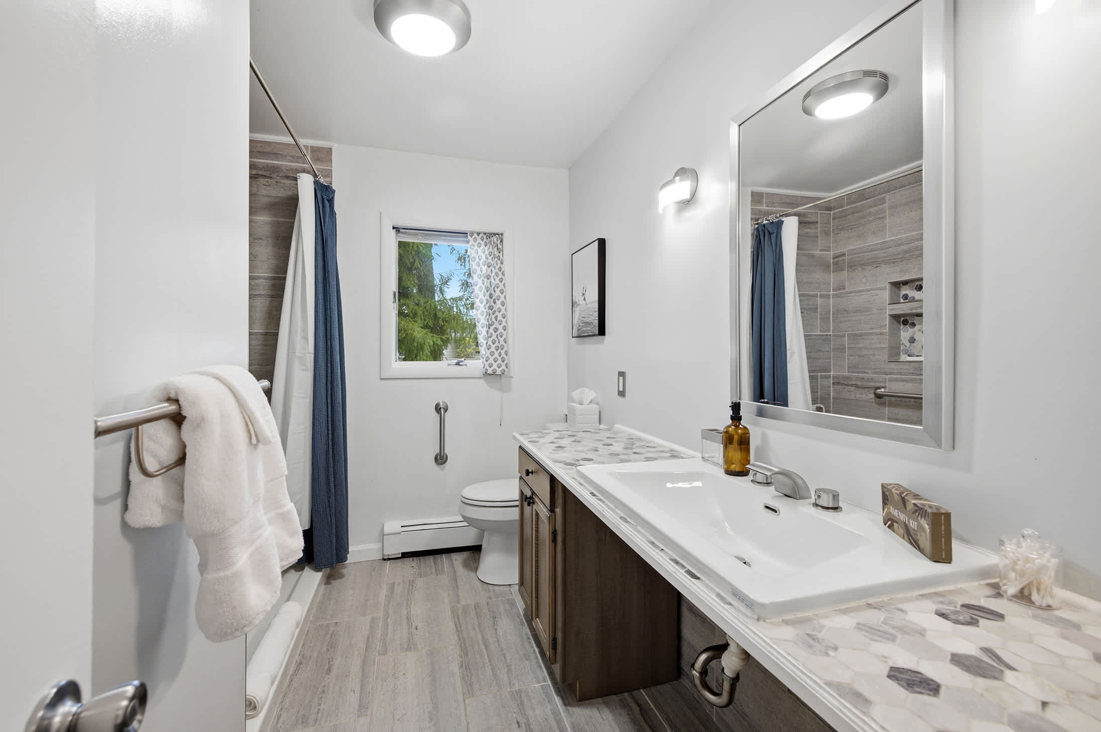 Full bathroom features a spacious vanity and shower/tub combination.