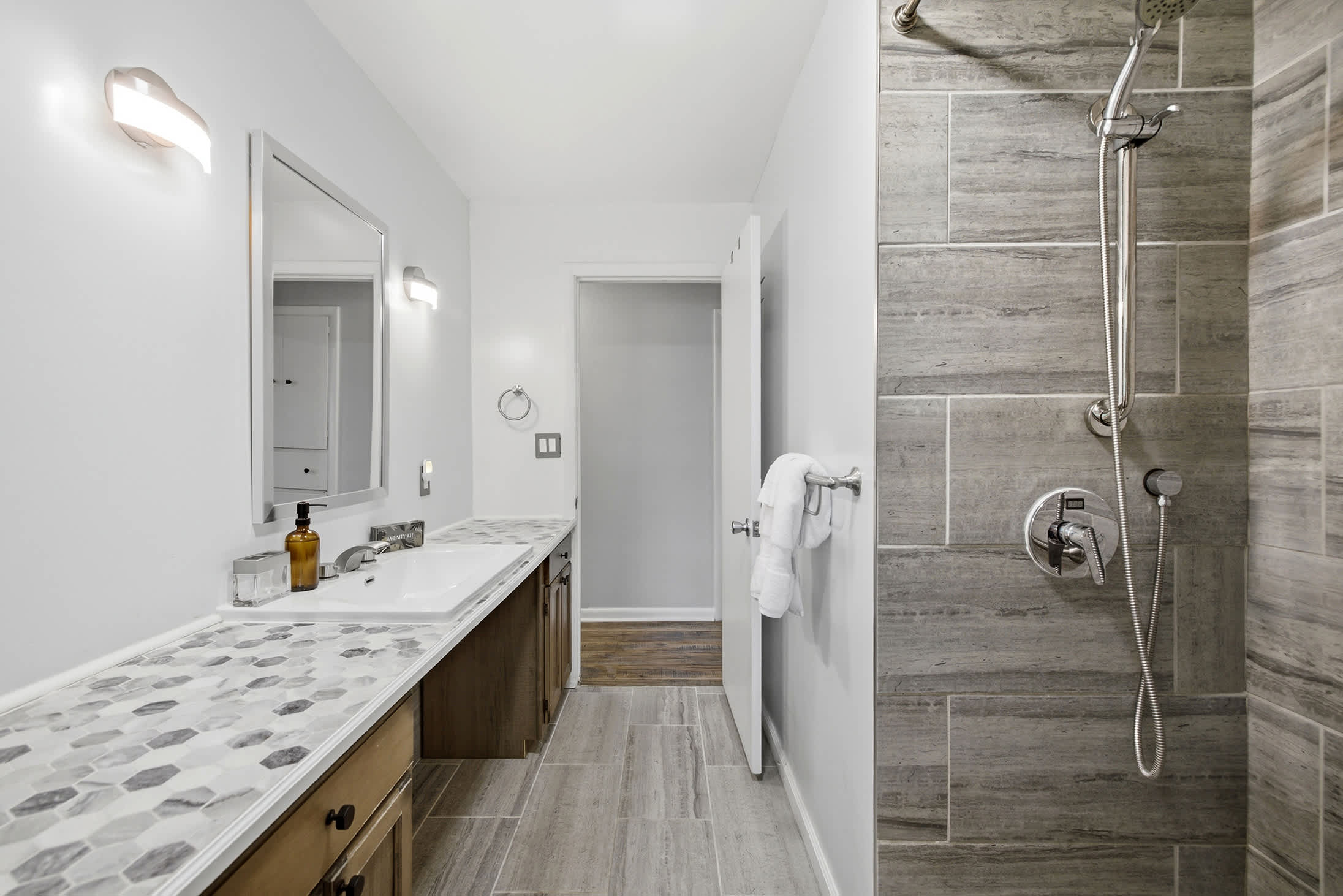 Walk in shower with grab bars offers added comfort and convenience.