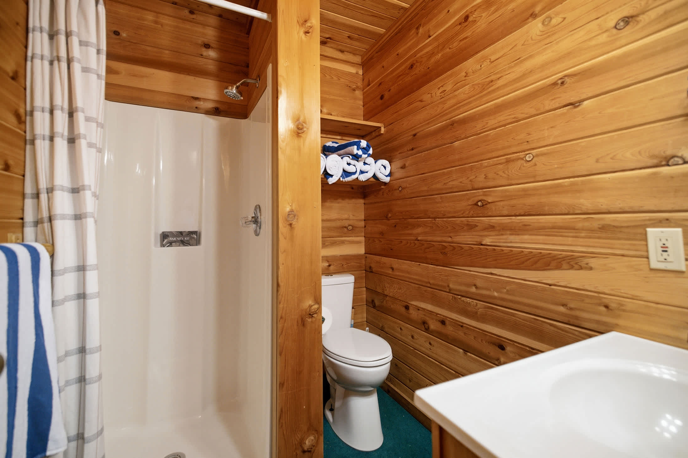 Pool house bathroom includes a shower for convenient post-swim rinses.