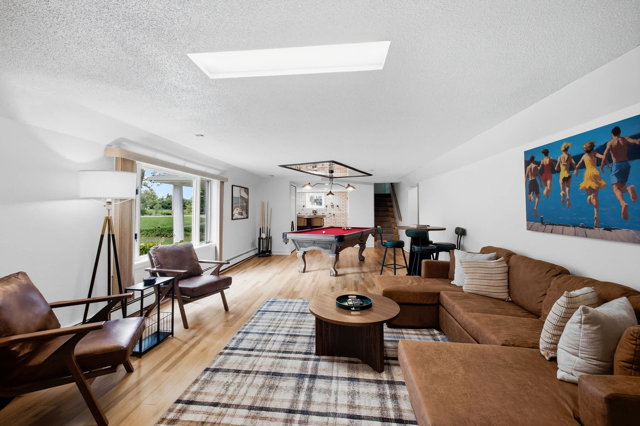 Spacious main-level lounge keeps seating and billiards all in one place.