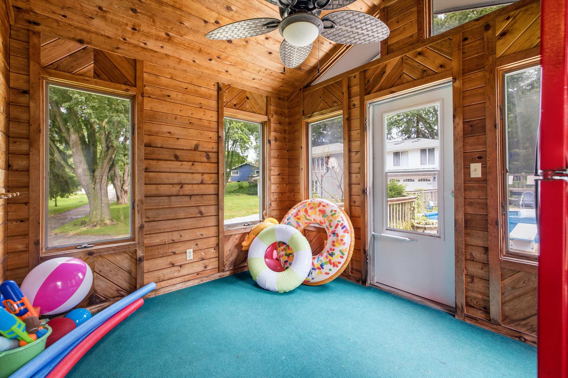 Pool house keeps floats and pool gear conveniently stored near the water.