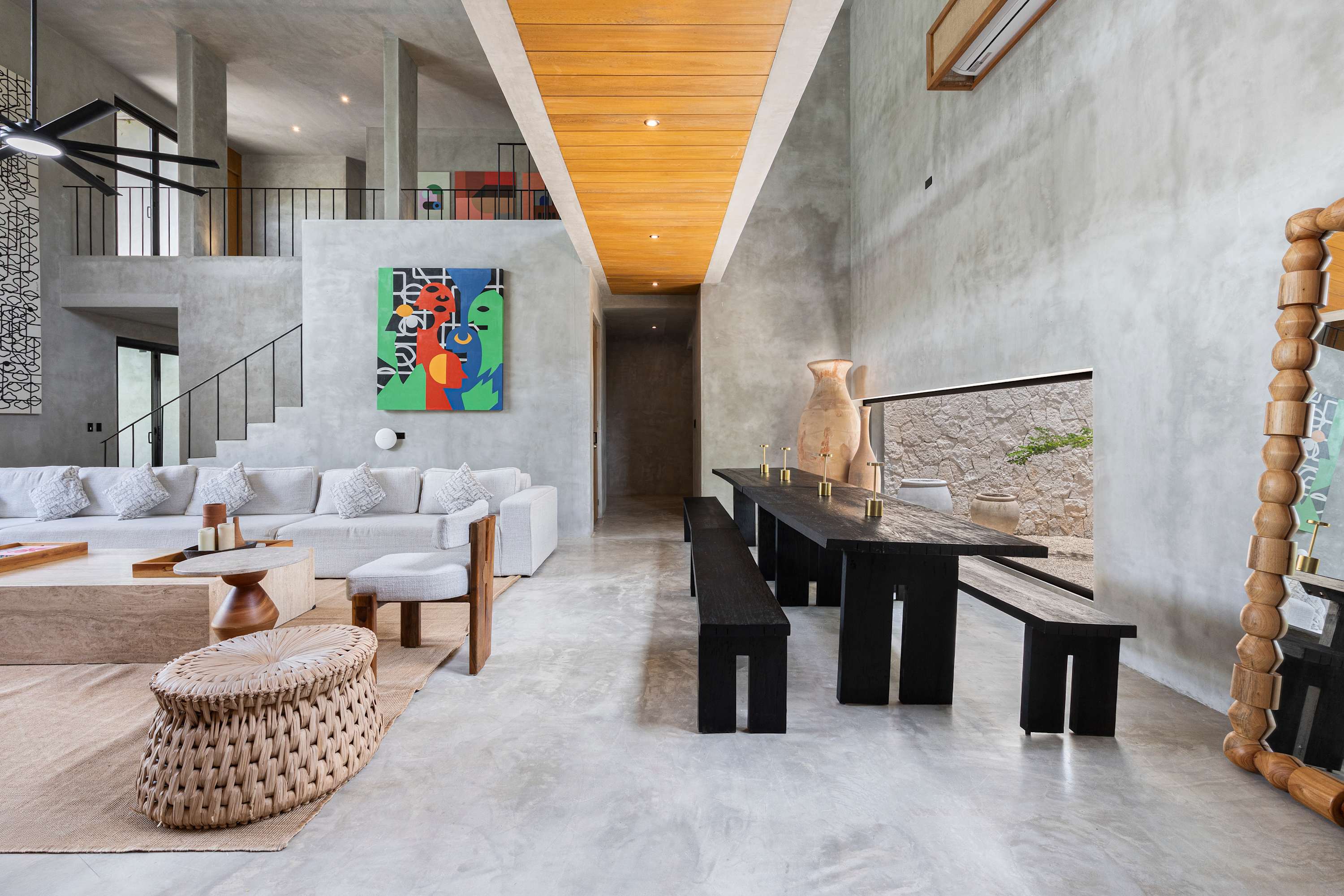 Elegant living room with striking brutalist architecture and soaring high ceilings for a sophisticated, modern vibe.