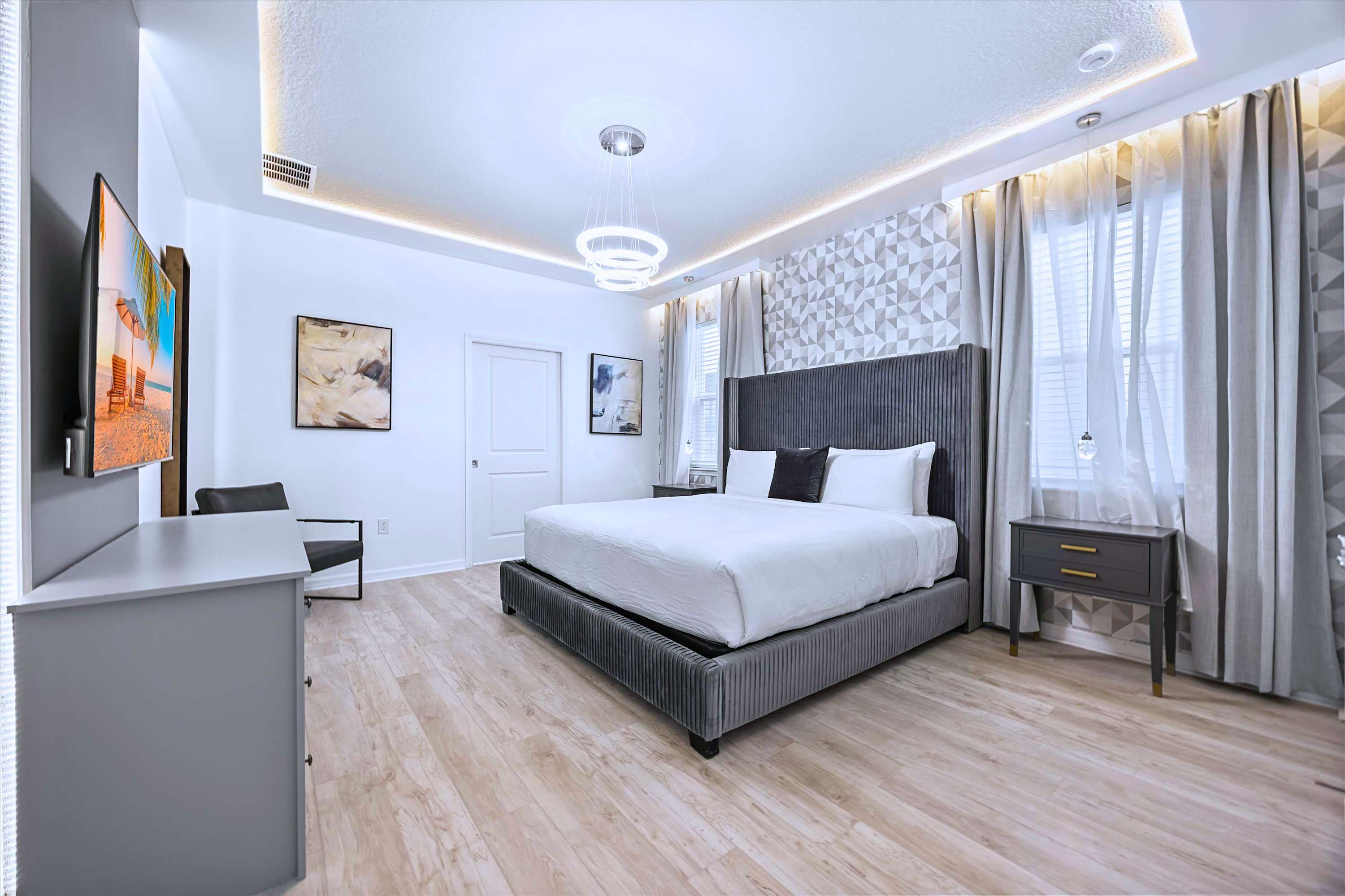 Grand King Bedroom Featuring Lounge Chair & Designer Ceiling