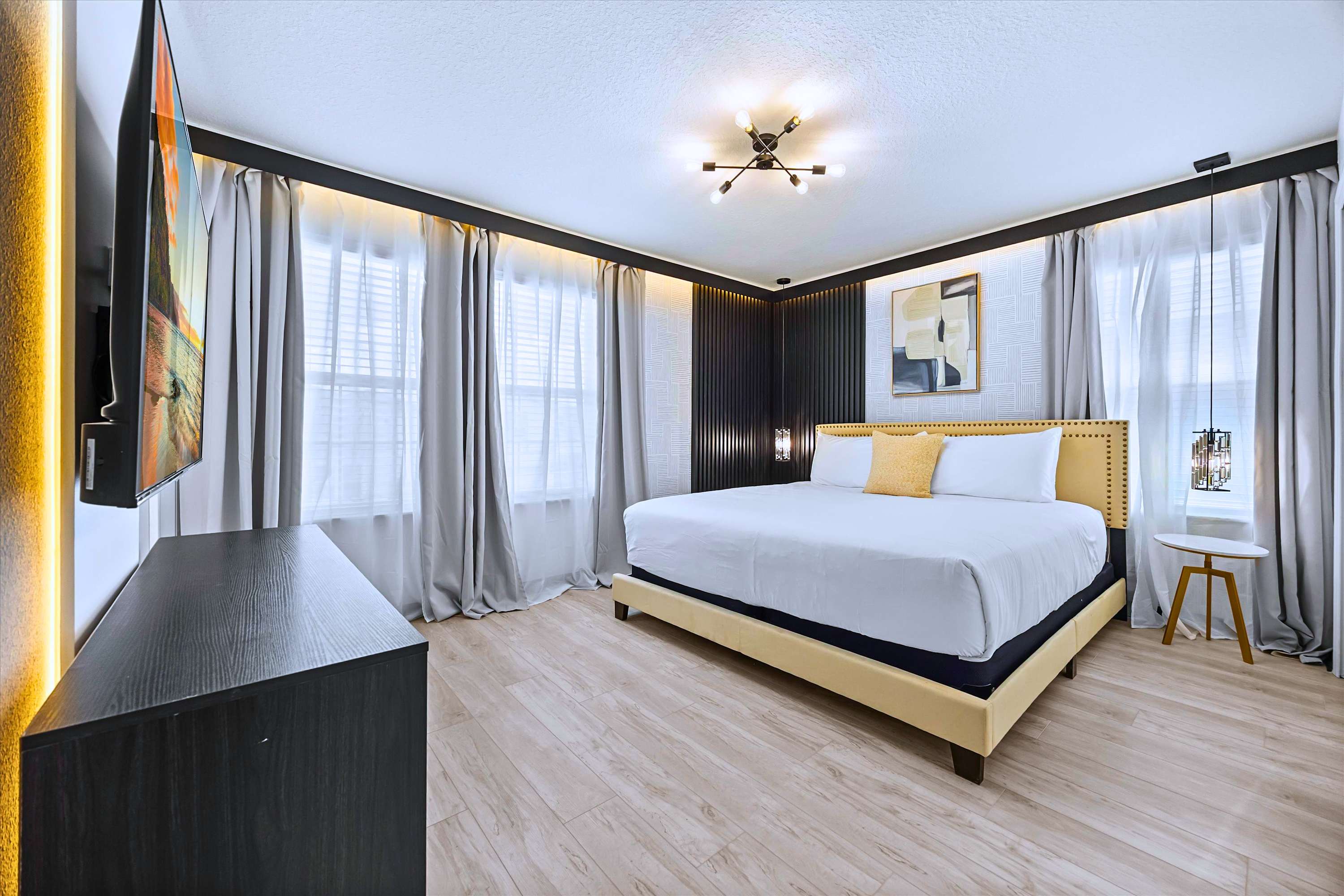 Relax & Stream Favorite Movies in Chic Chandelier King Bedroom