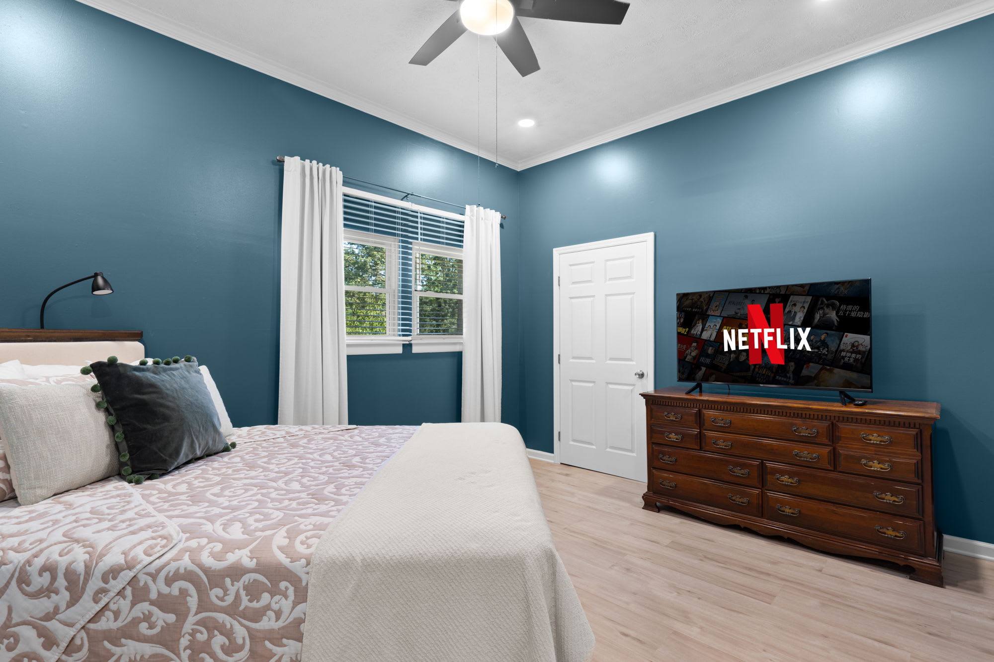 Downstairs private primary bedroom with a smart TV