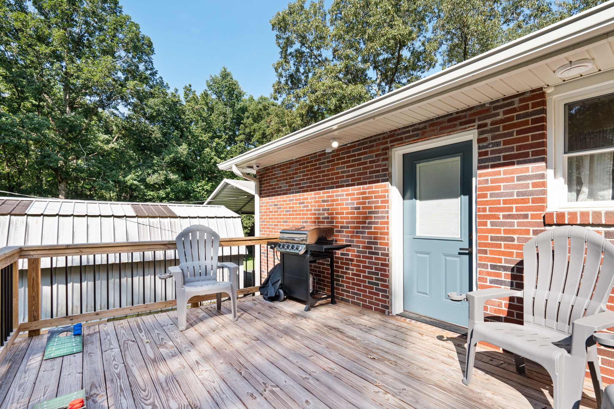 Back porch with a propane grill, outdoor seating, & games
