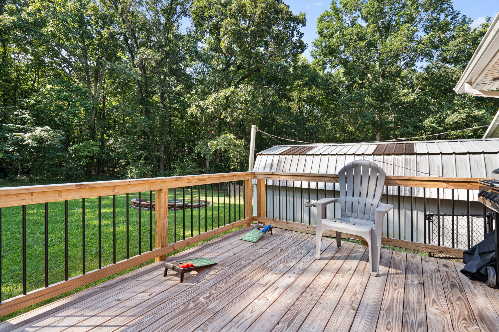 Back porch with a propane grill, outdoor seating, & games
