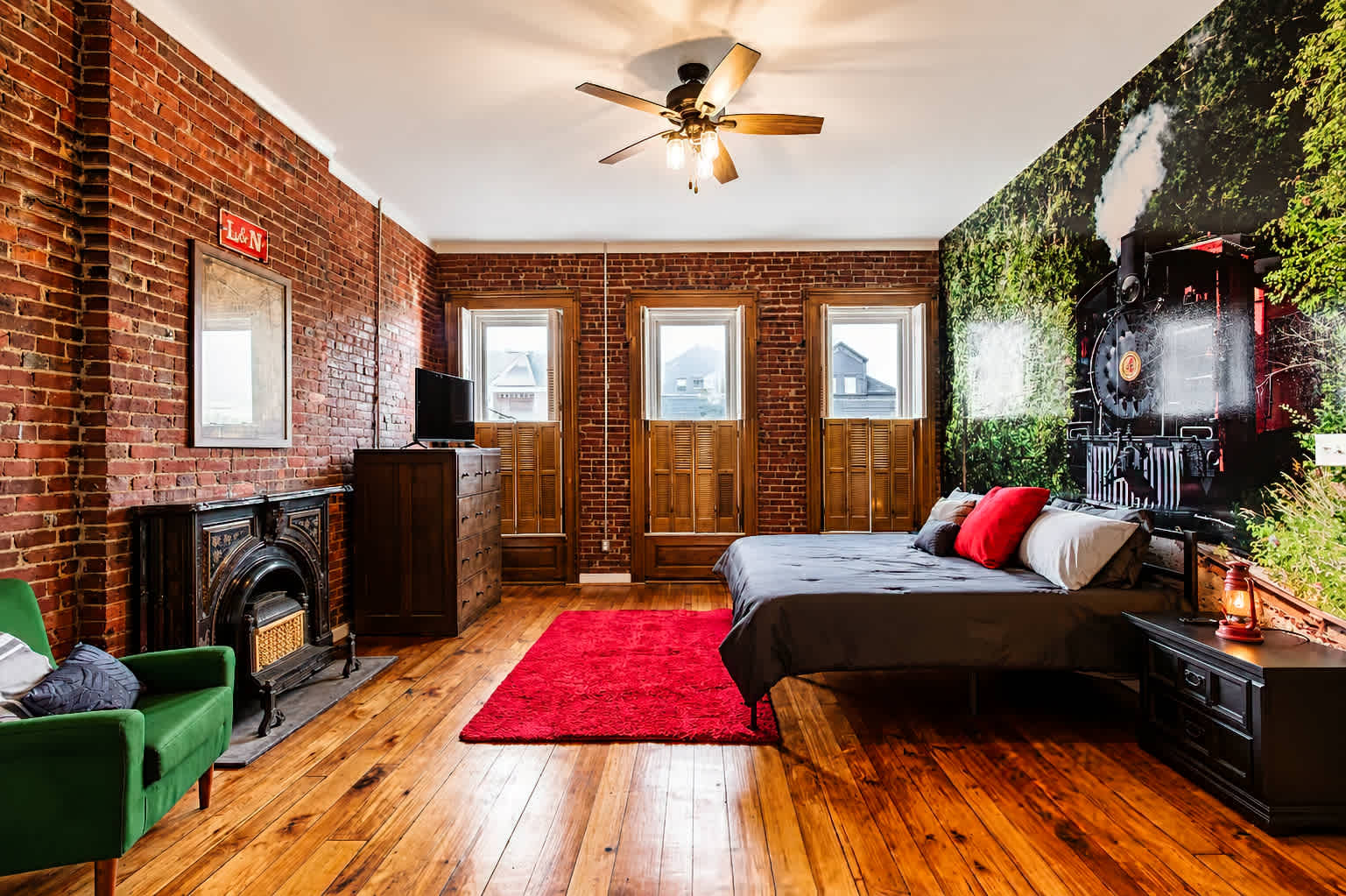Master Suite with king bed, smart TV, decorative fireplace, and private mini bar