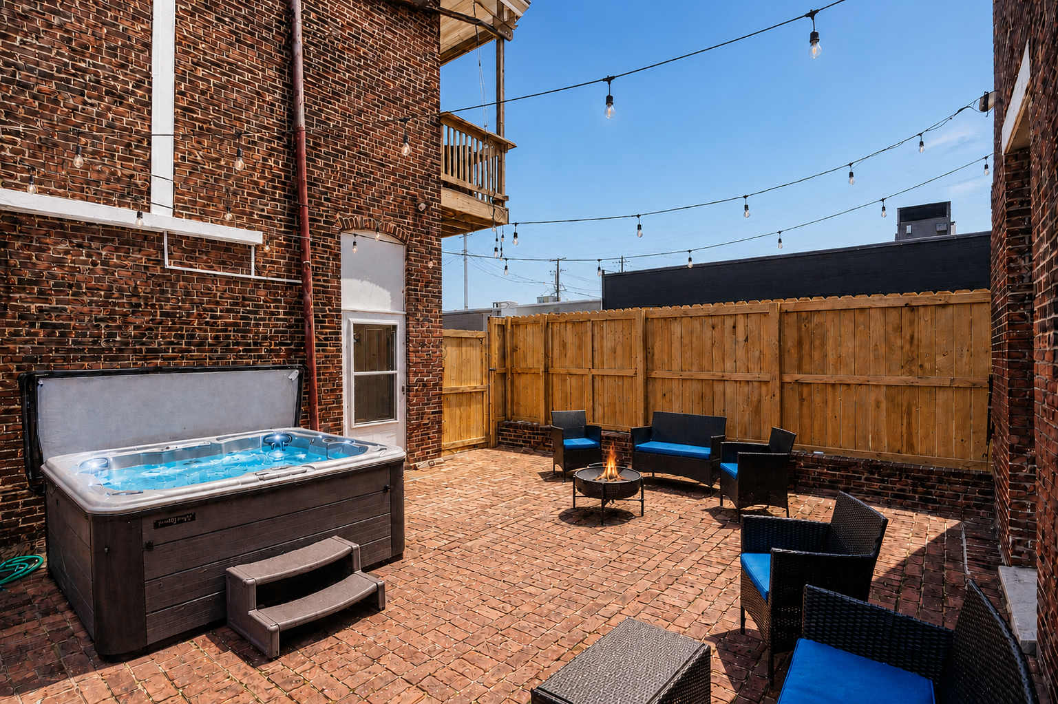 Private courtyard with hot tub, firepit, and lounge seating