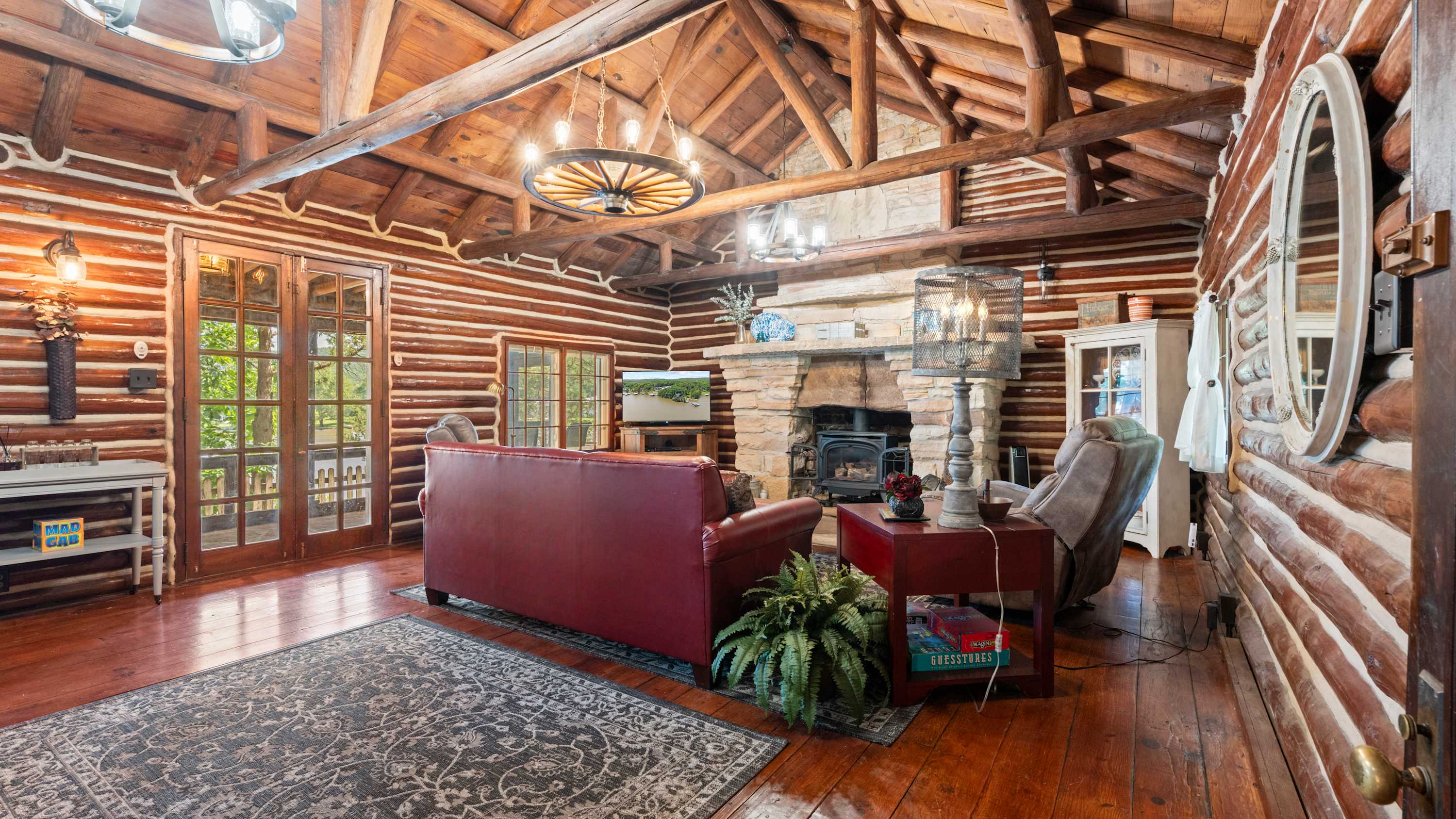 Main cabin living room with smart TV, queen sleeper, and Murphy bed