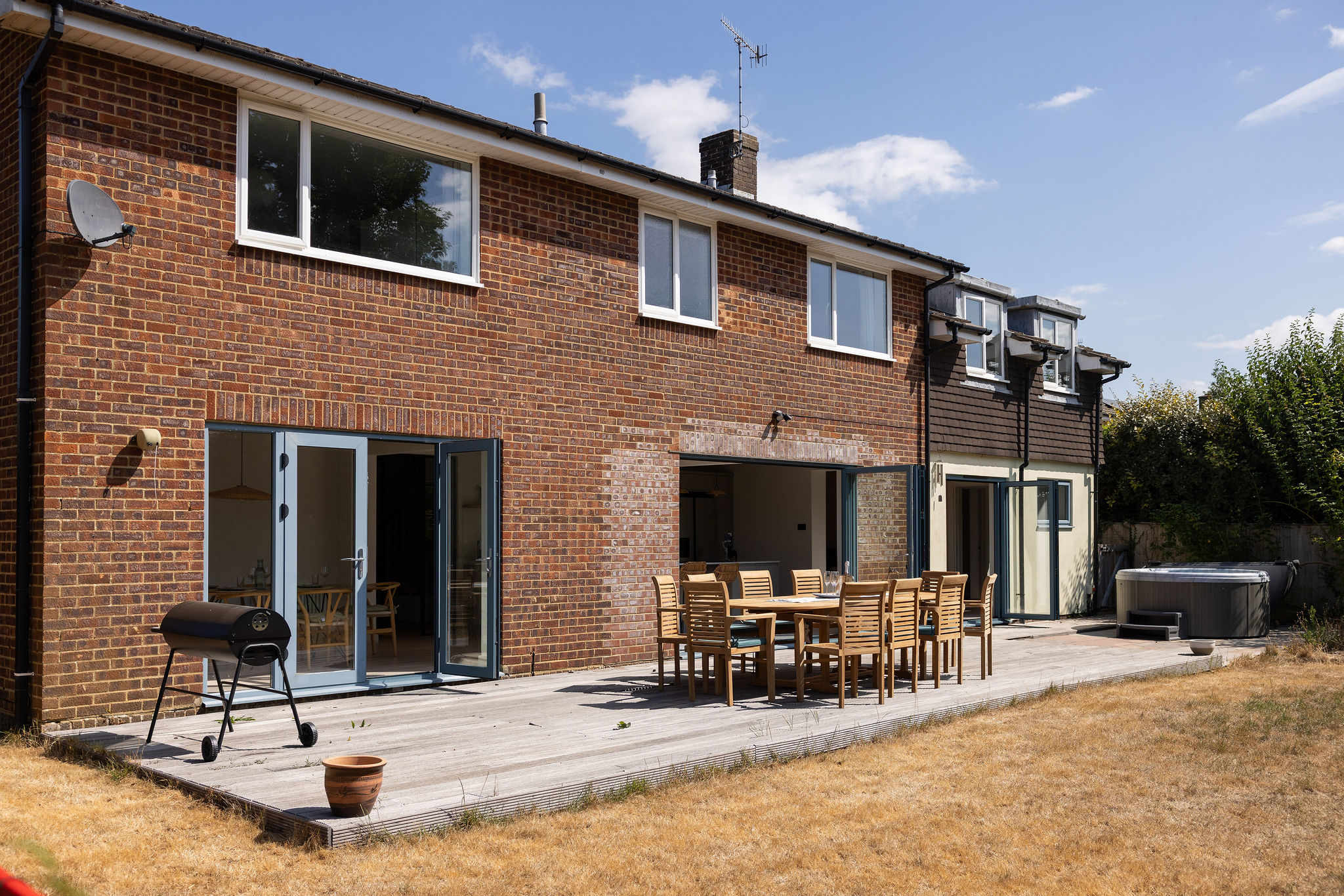 Designed for effortless outdoor living, the spacious deck brings together alfresco dining, a BBQ and private hot tub, opening seamlessly onto the generous lawn beyond.