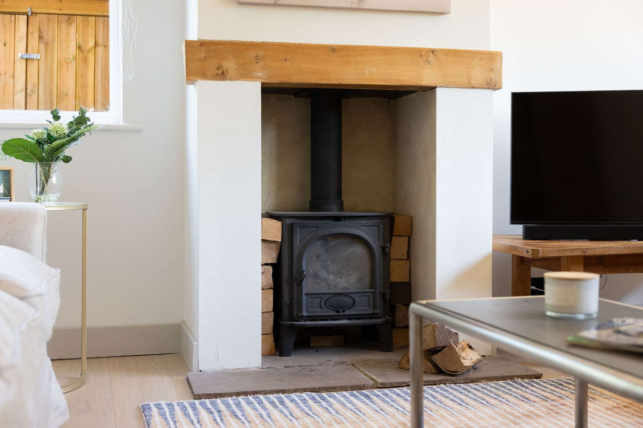 The cosy log burner adds warmth and character to the lounge, creating the perfect spot to relax and unwind on cooler days.