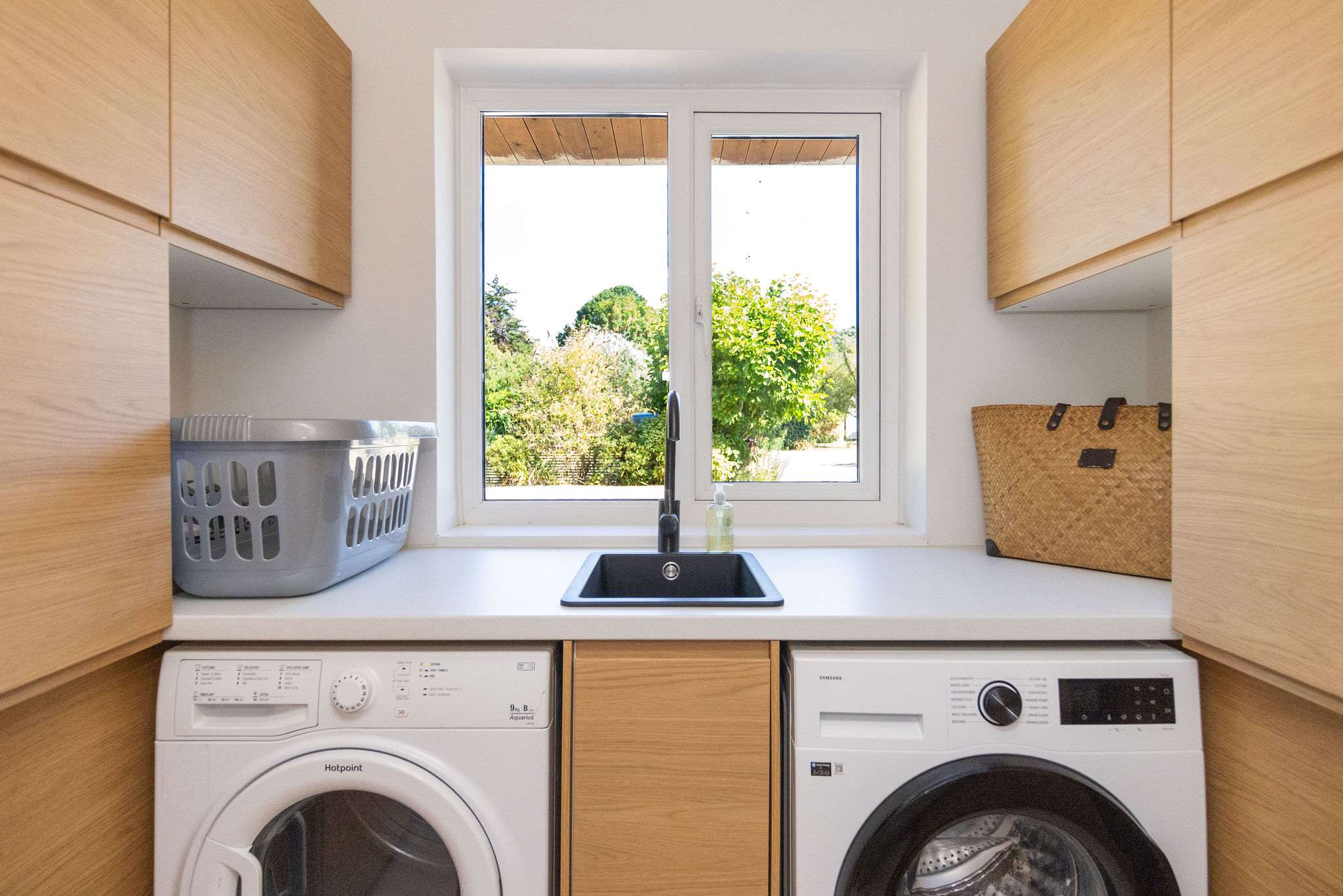 A well-equipped utility room with sink, washing machine, tumble dryer and plenty of cupboard storage — everything you need to make longer stays and family holidays feel effortless.