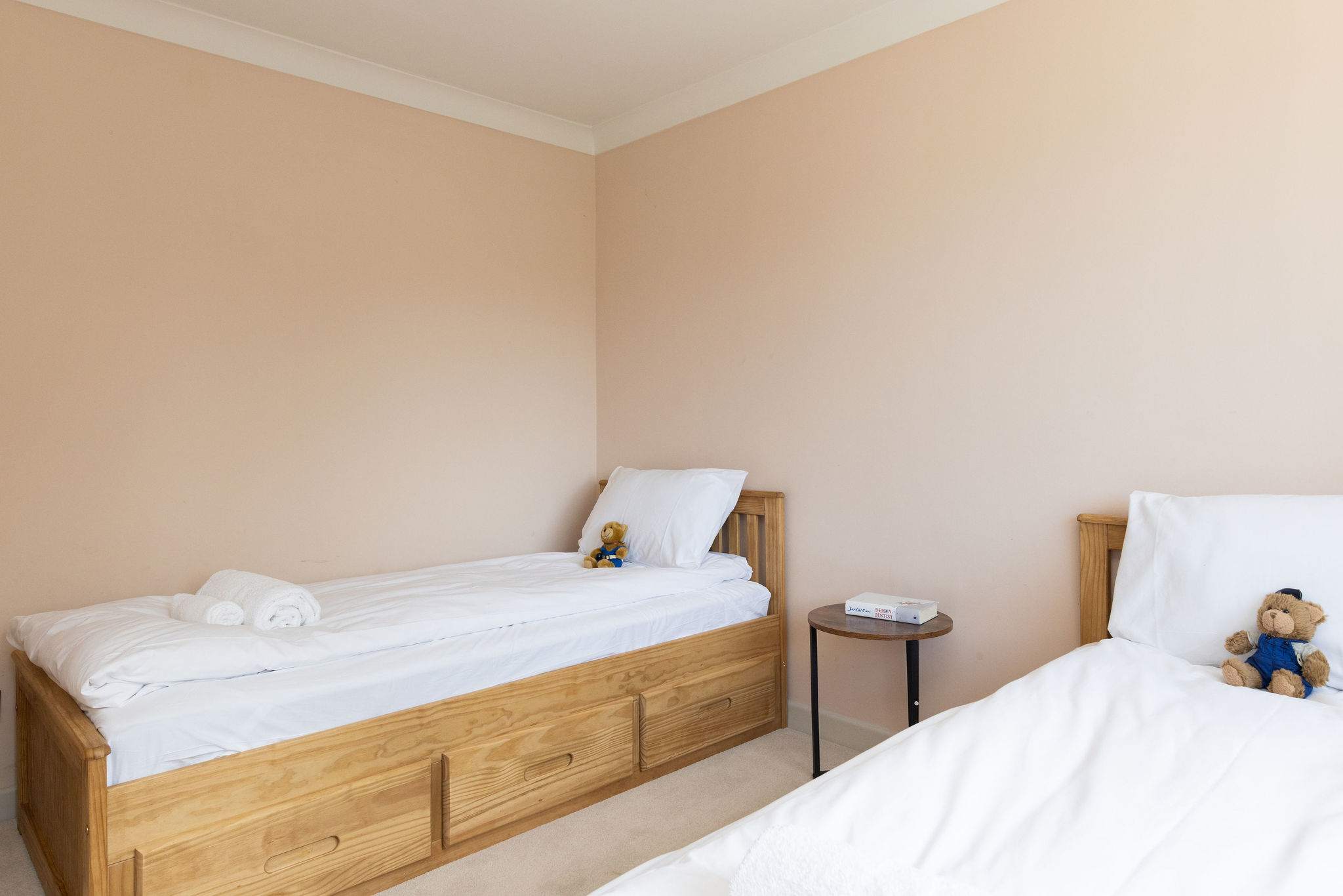 A sweet and welcoming twin bedroom, simply styled to create a calm, comfortable space for a restful night’s sleep.