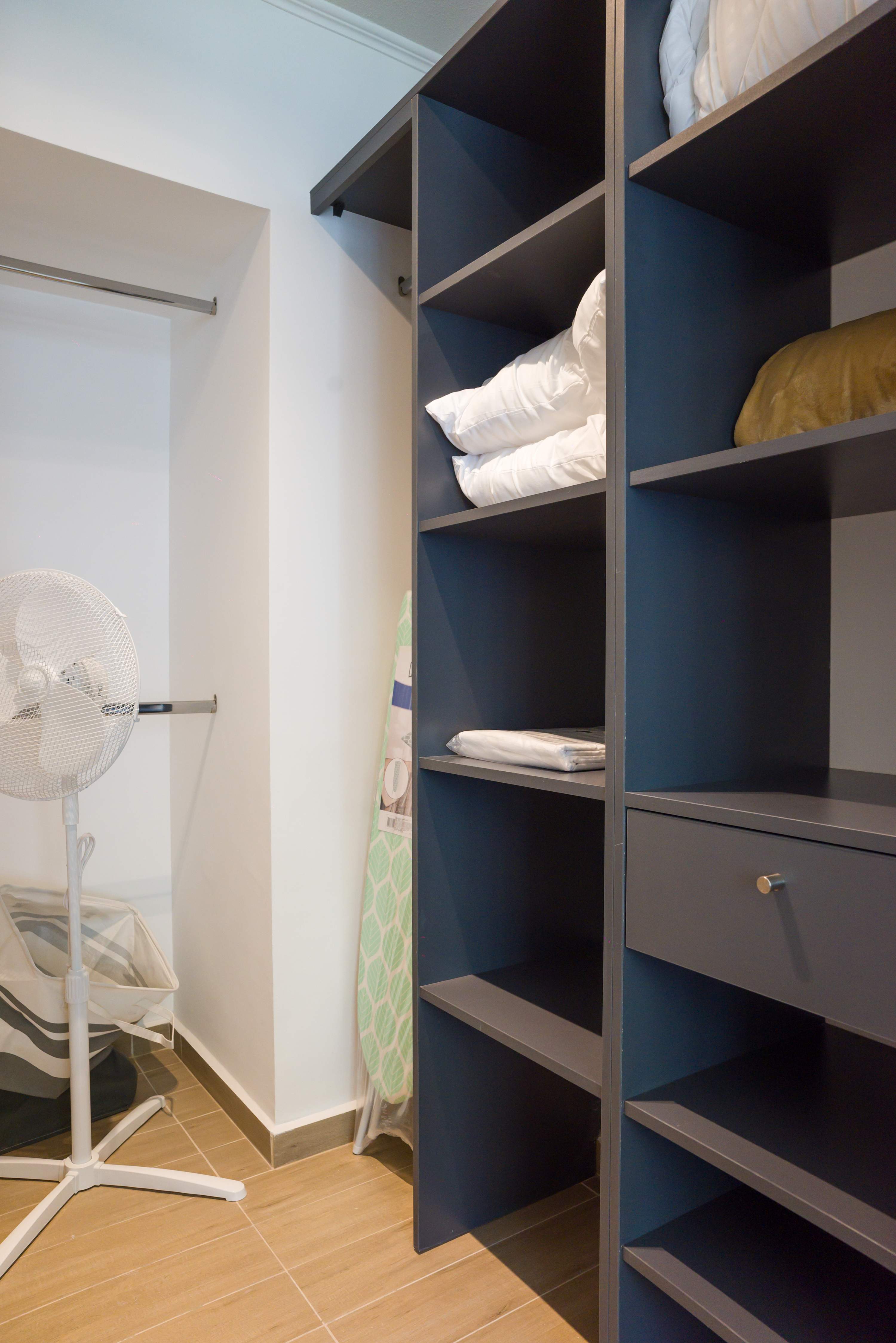 Private bunk bedroom with built-in dark wood bunks, crisp white bedding, and blue interior panels for a practical family sleeping area.