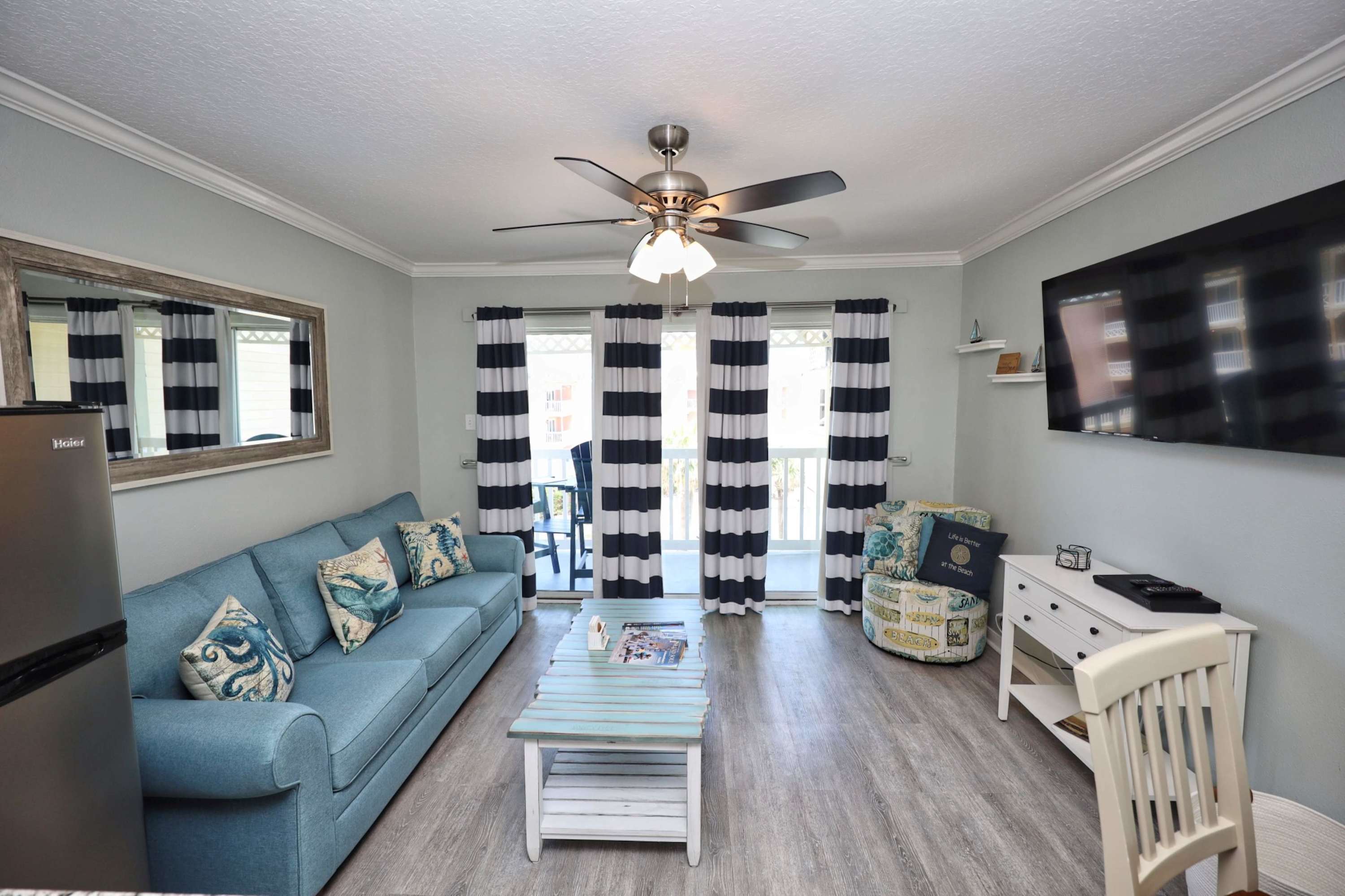 Curl up in the coastal chic living room & stream your favorites on the smart TV​