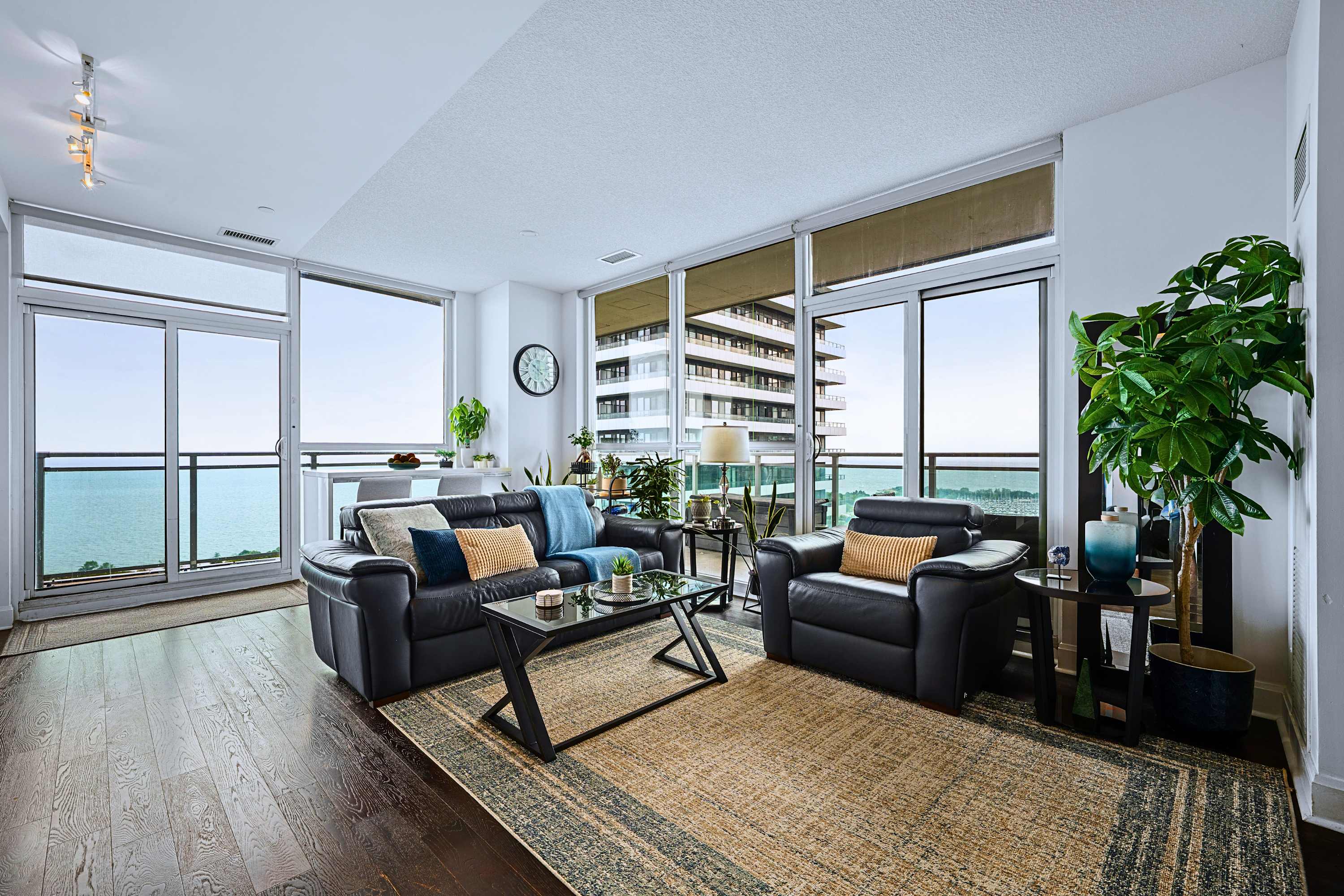 Living room with large glass windows overlooking stunning outdoor city views.
