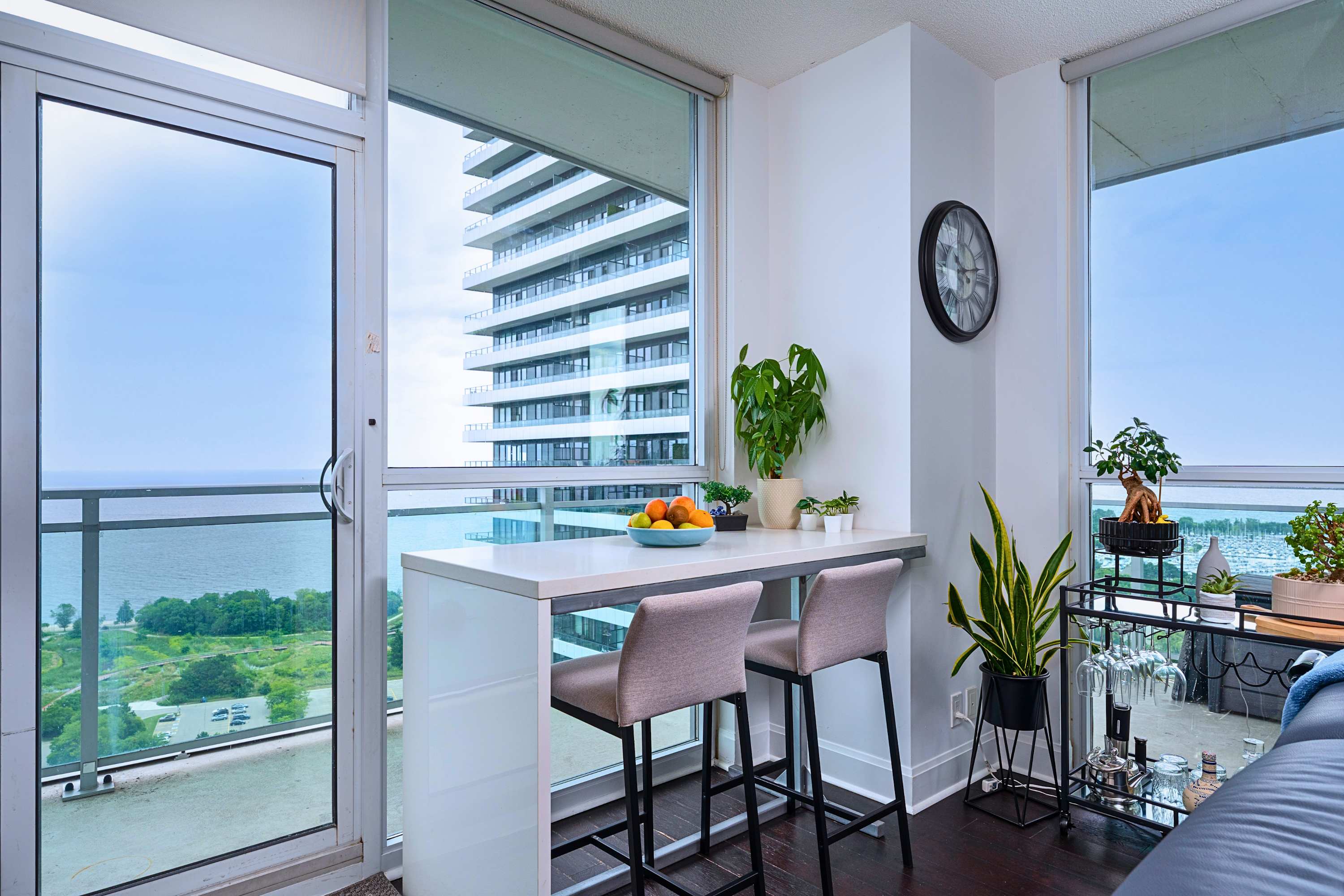 High table with high chairs facing clear, scenic city views.