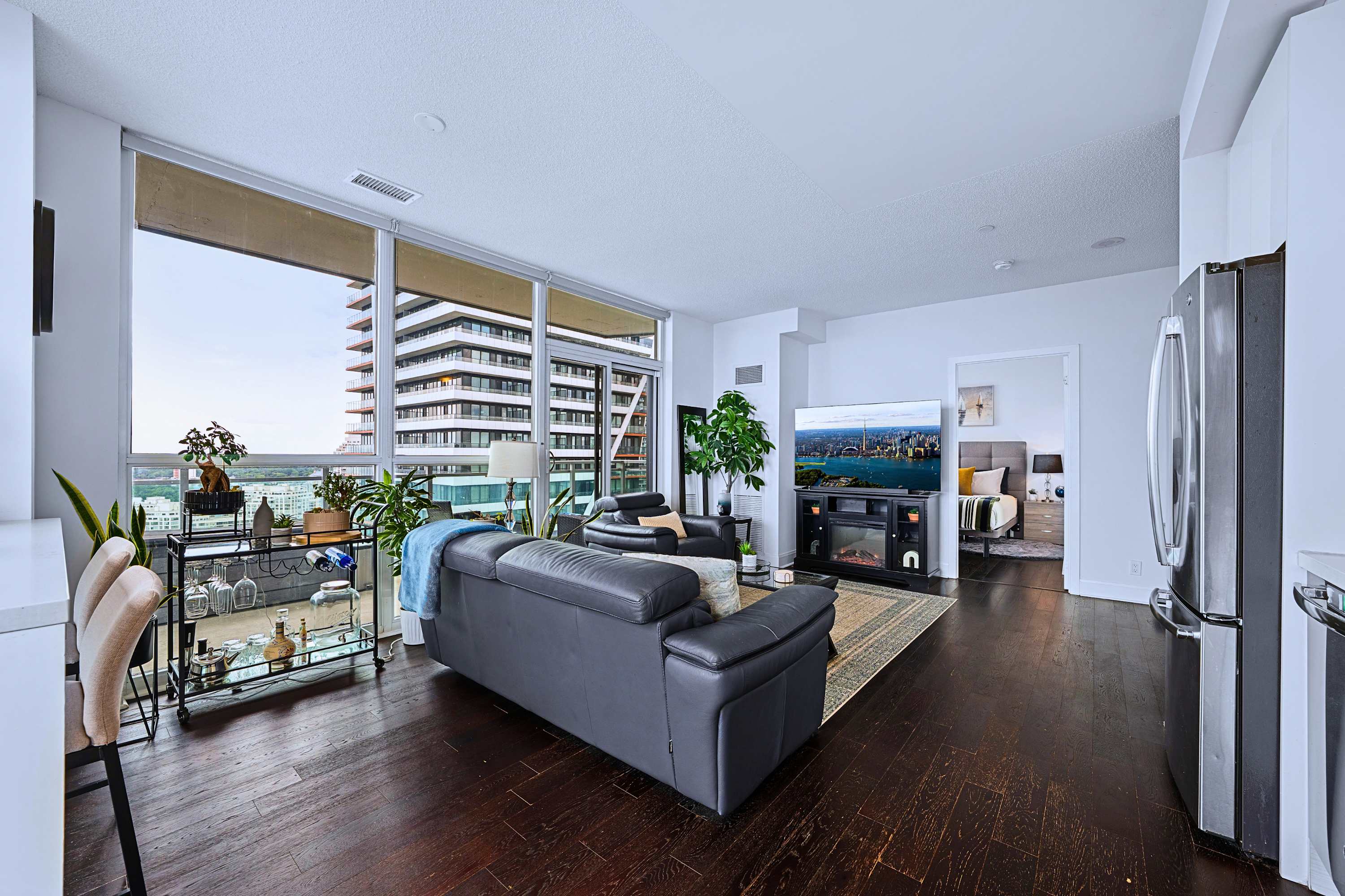 Central living room with couch, TV, high table, scenic views, and easy layout access.