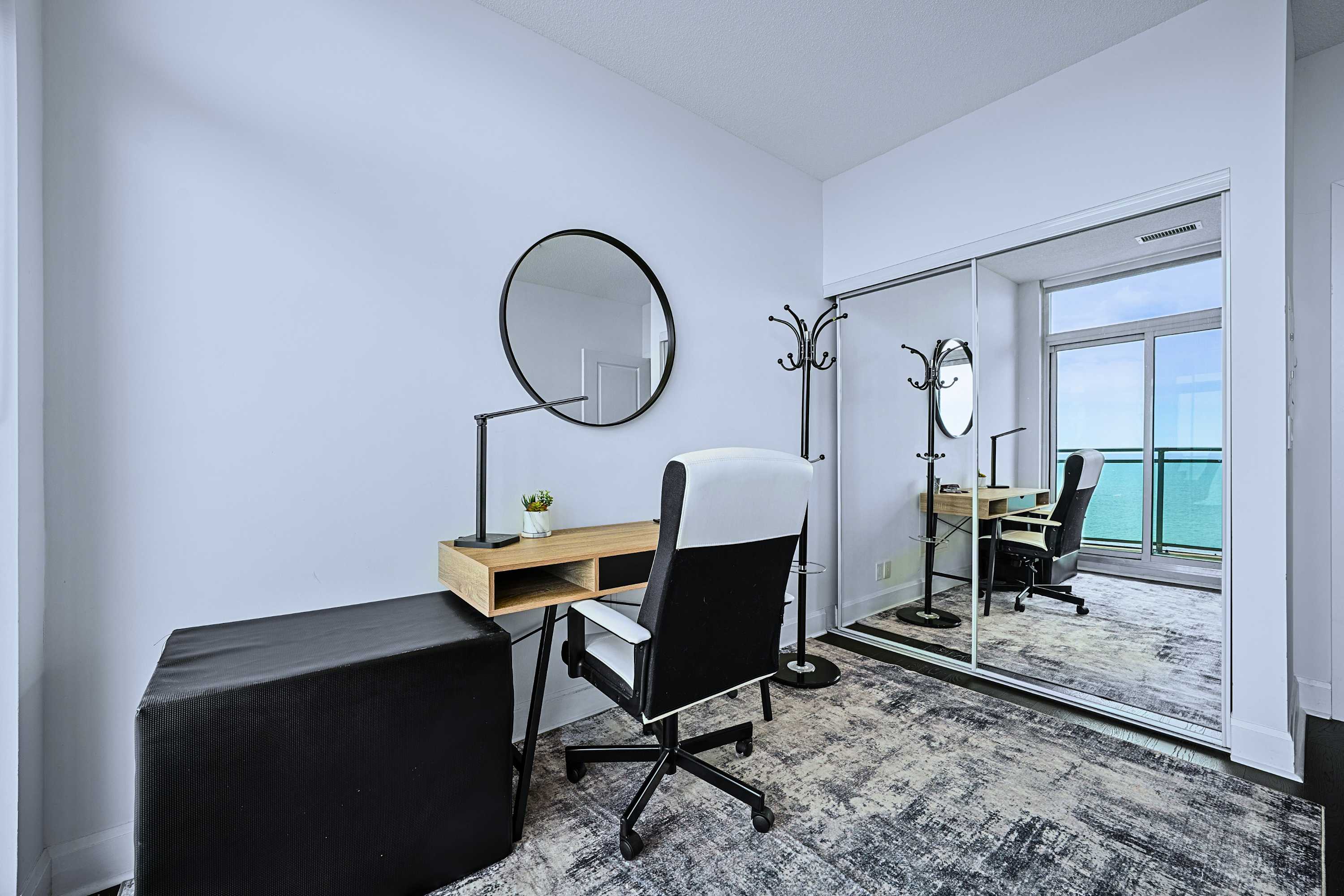 Quiet workspace table with chairs, city views, and seamless balcony access.