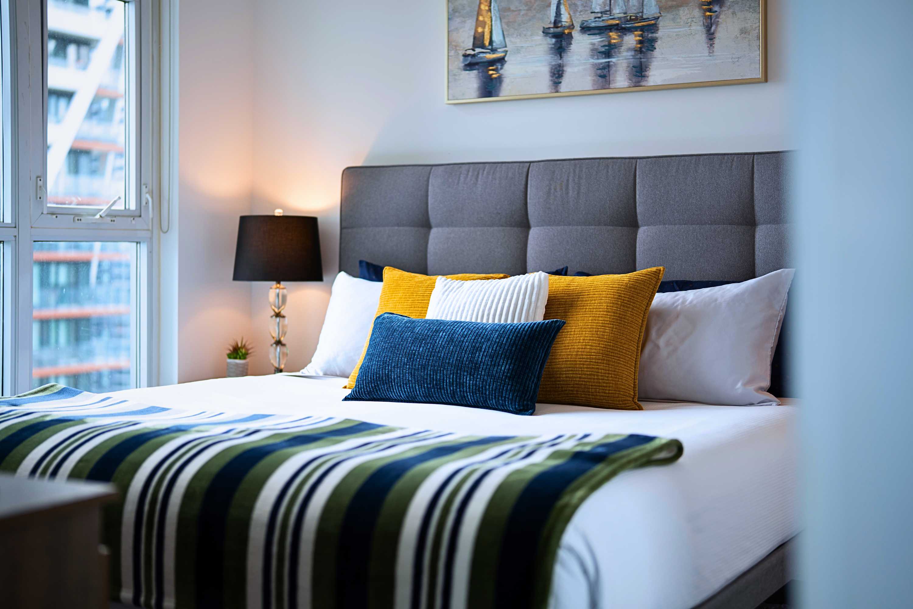 King bed with modern design aesthetics and plush, high-end bed sheets.