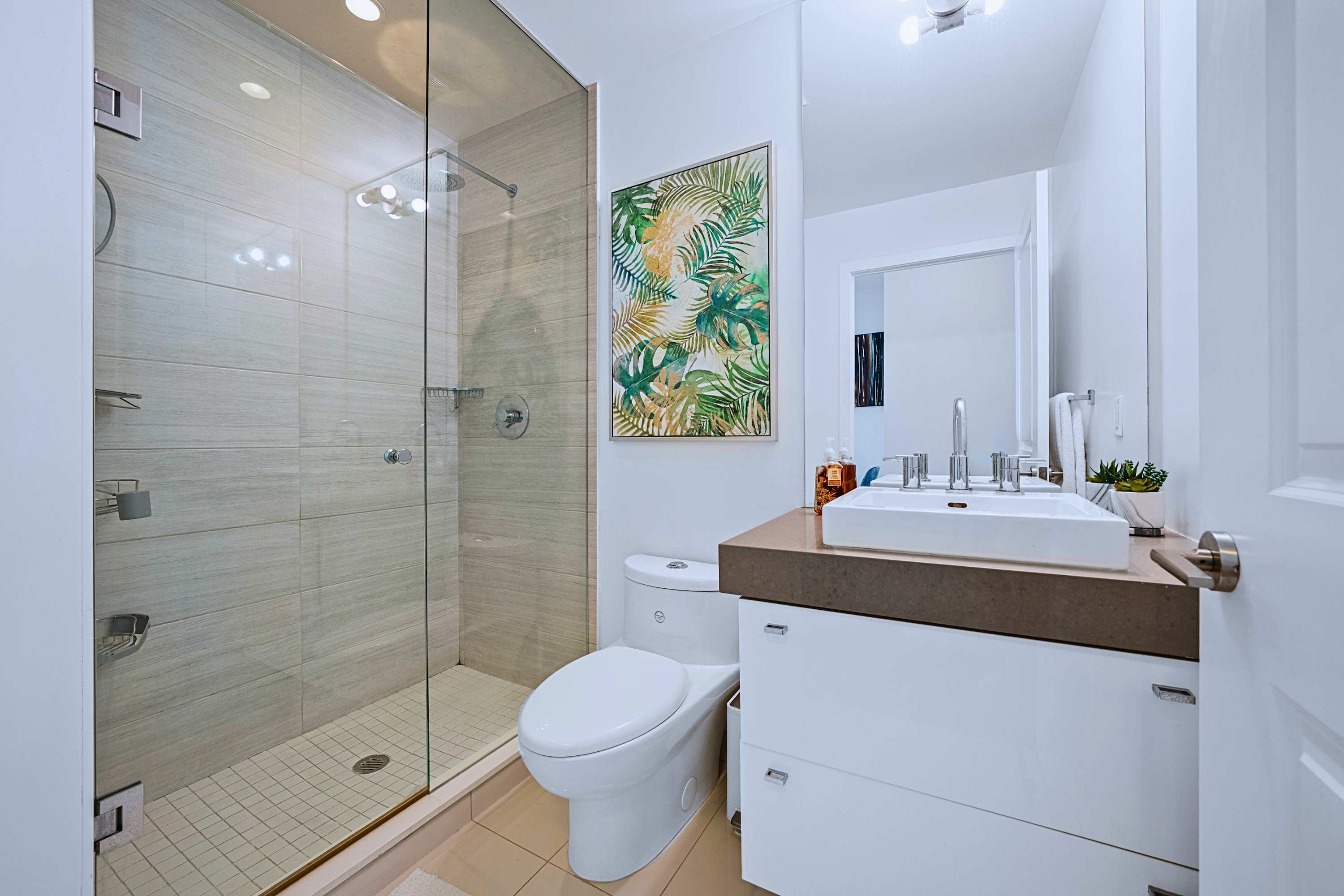 Ensuite bathroom complete with a vanity mirror, toilet, and walk-in shower.
