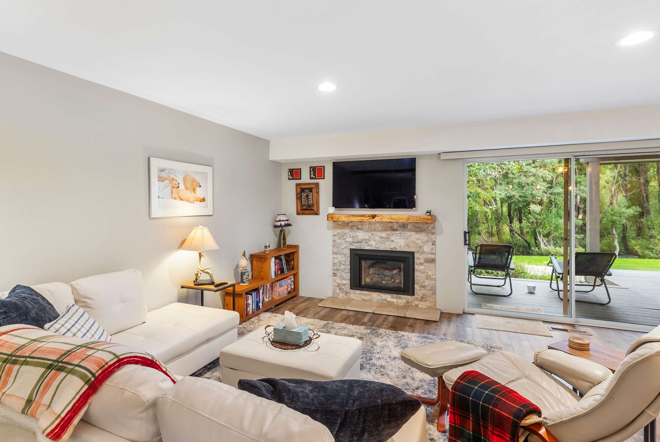 Living room w/ fireplace, smart TV, sleeper sofa, & patio access