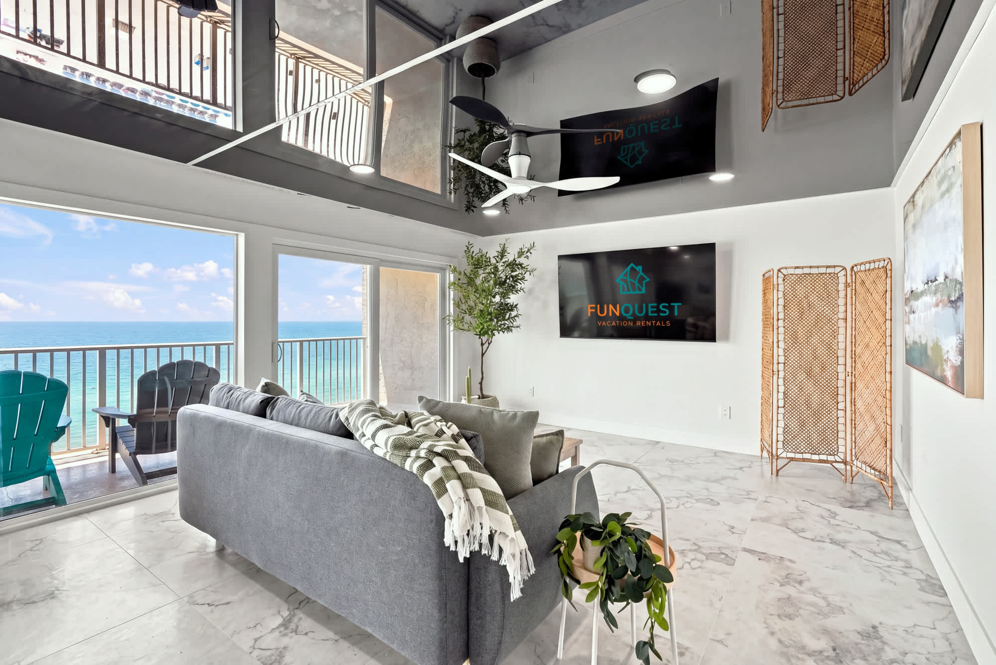 The Summit 1512 – Modern living room with ocean view, sectional sofa, wall-mounted TV, and balcony access.