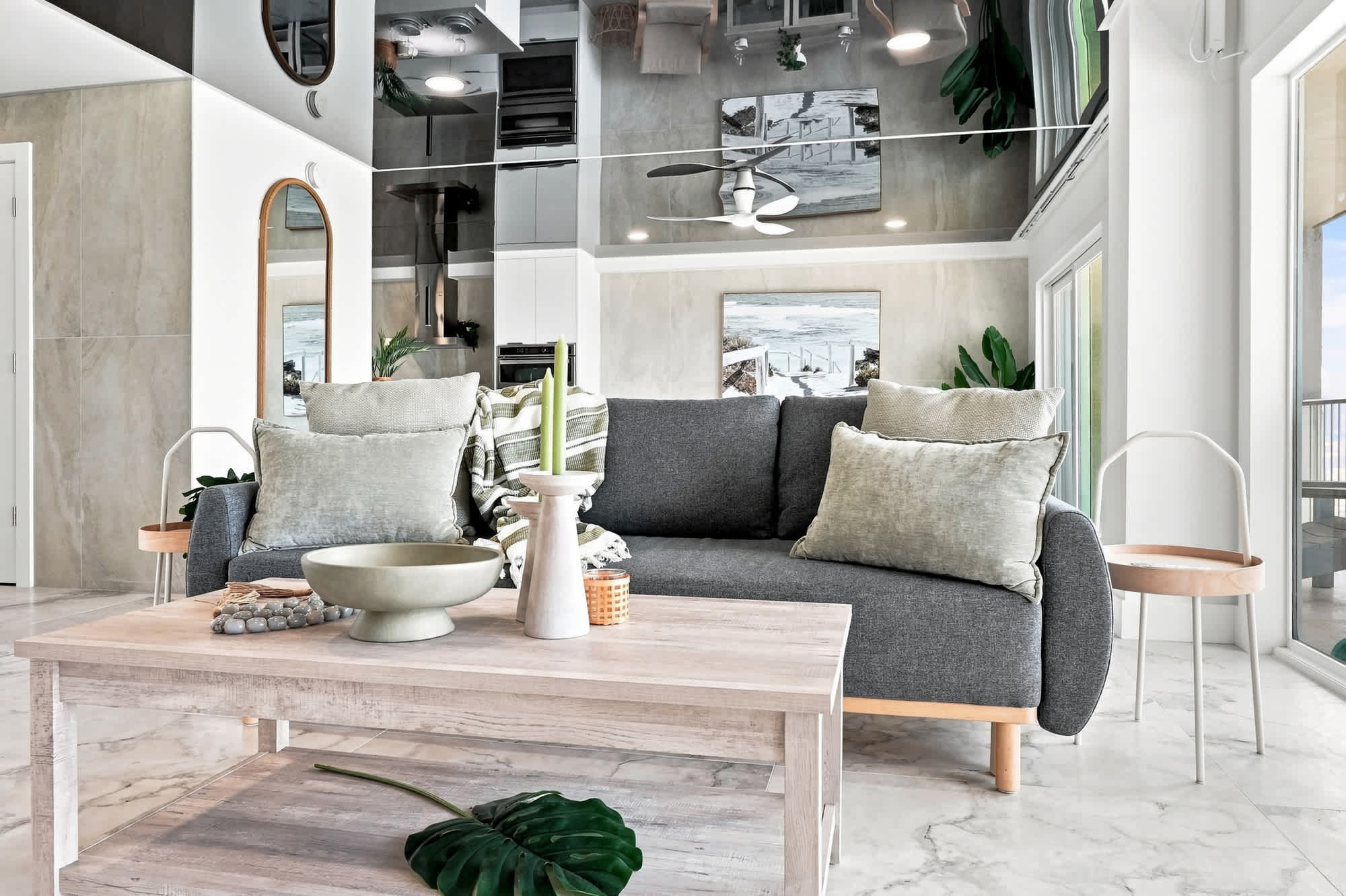The Summit 1512 – Stylish living room with modern furniture, large windows, and a view of the outdoor balcony.