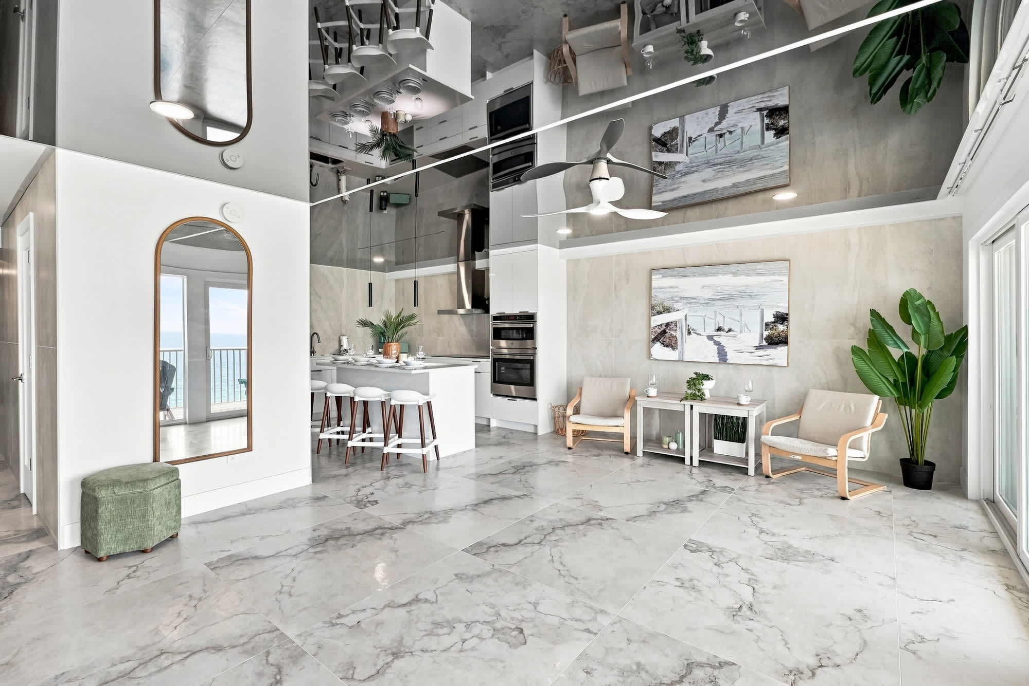The Summit 1512 – Modern living area with marble floors, kitchen island, seating, and ocean view through large windows.