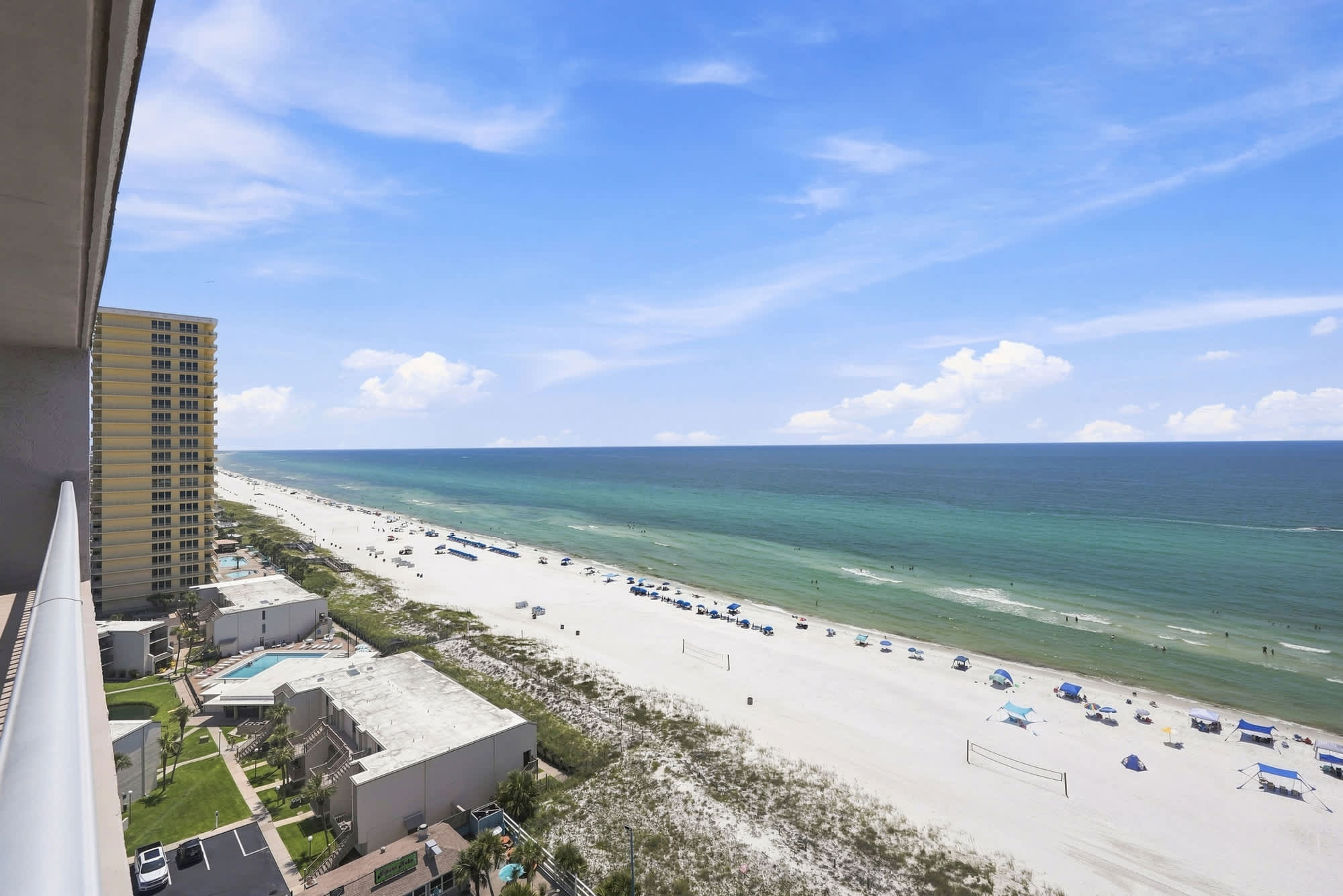 The Summit 1512 – View from balcony showcasing beach, ocean, and nearby buildings in a sunny locale.