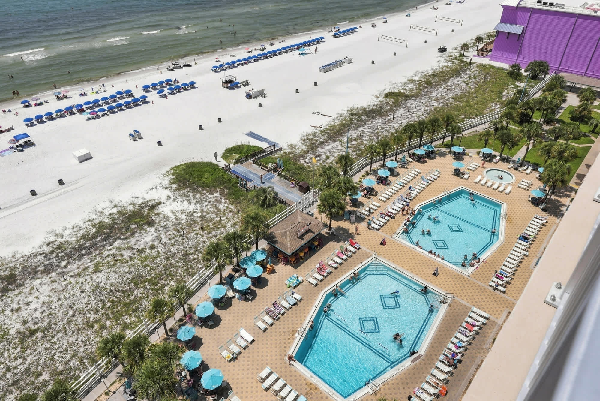 The Summit 1512 – Elevated view of pools, beach, umbrellas, and lounges at The Summit 1512.