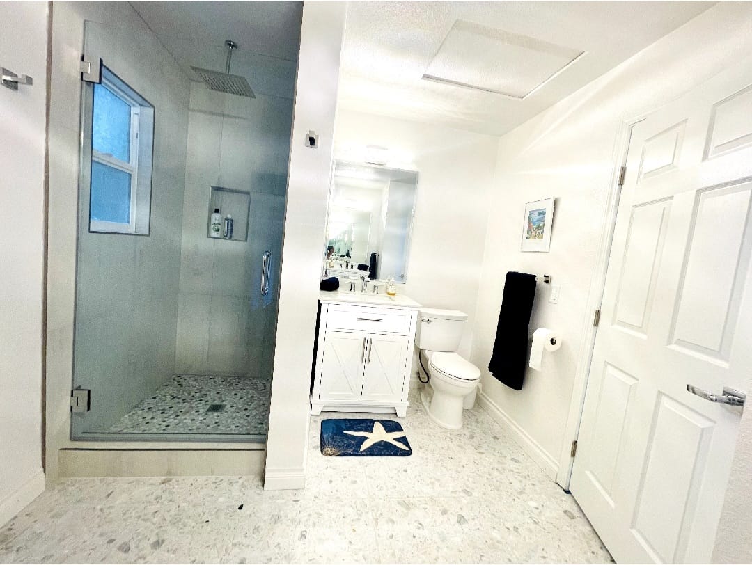 Attached Junior ADU Full Bathroom with walk-in shower and two sinks.