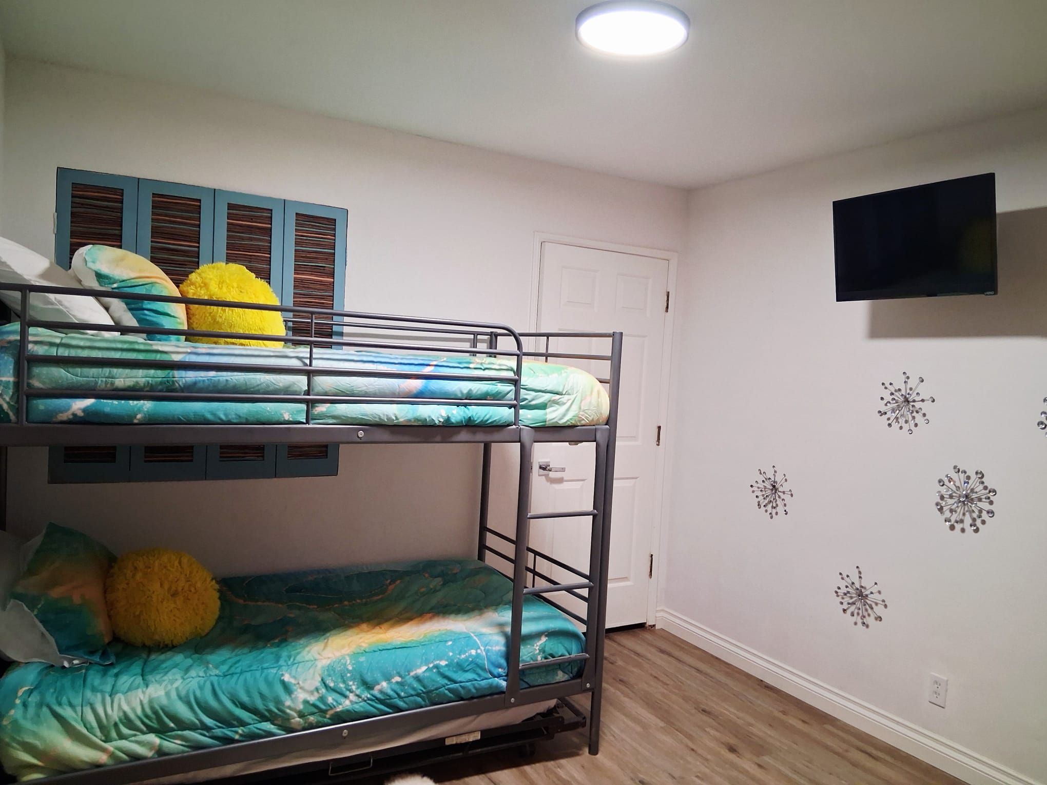 Guest Bedroom #3 provides a bunk bed with two singles and a TV.